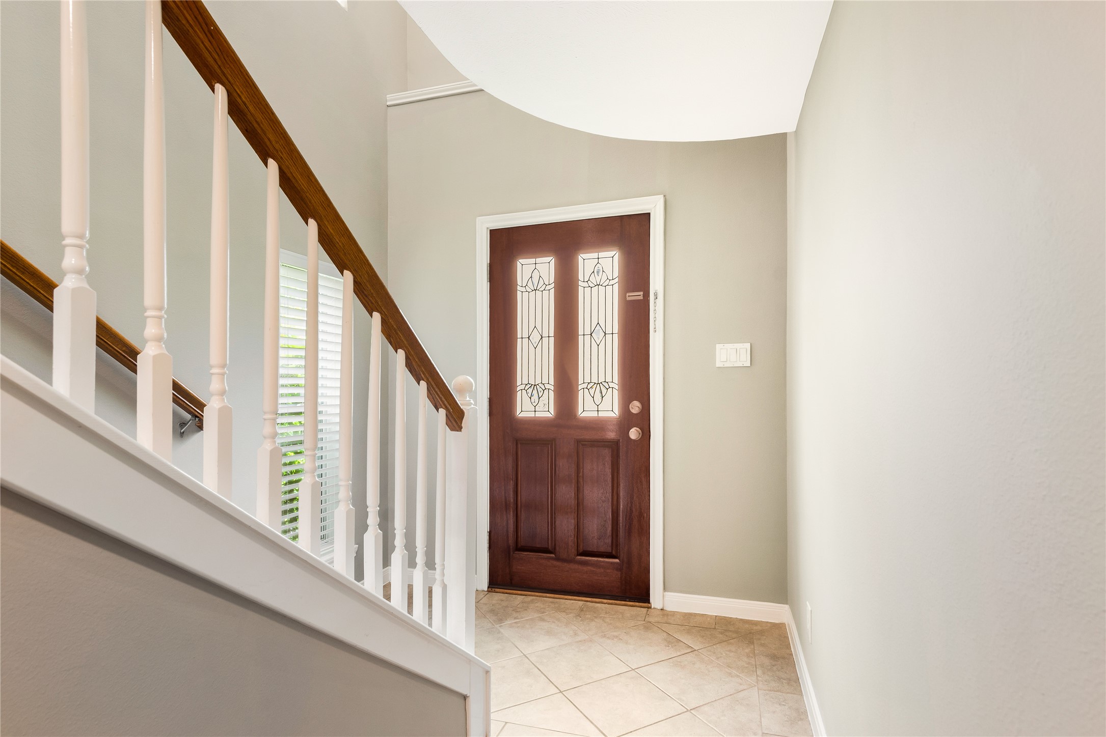 1st level front entry with tile flooring with abundance of light