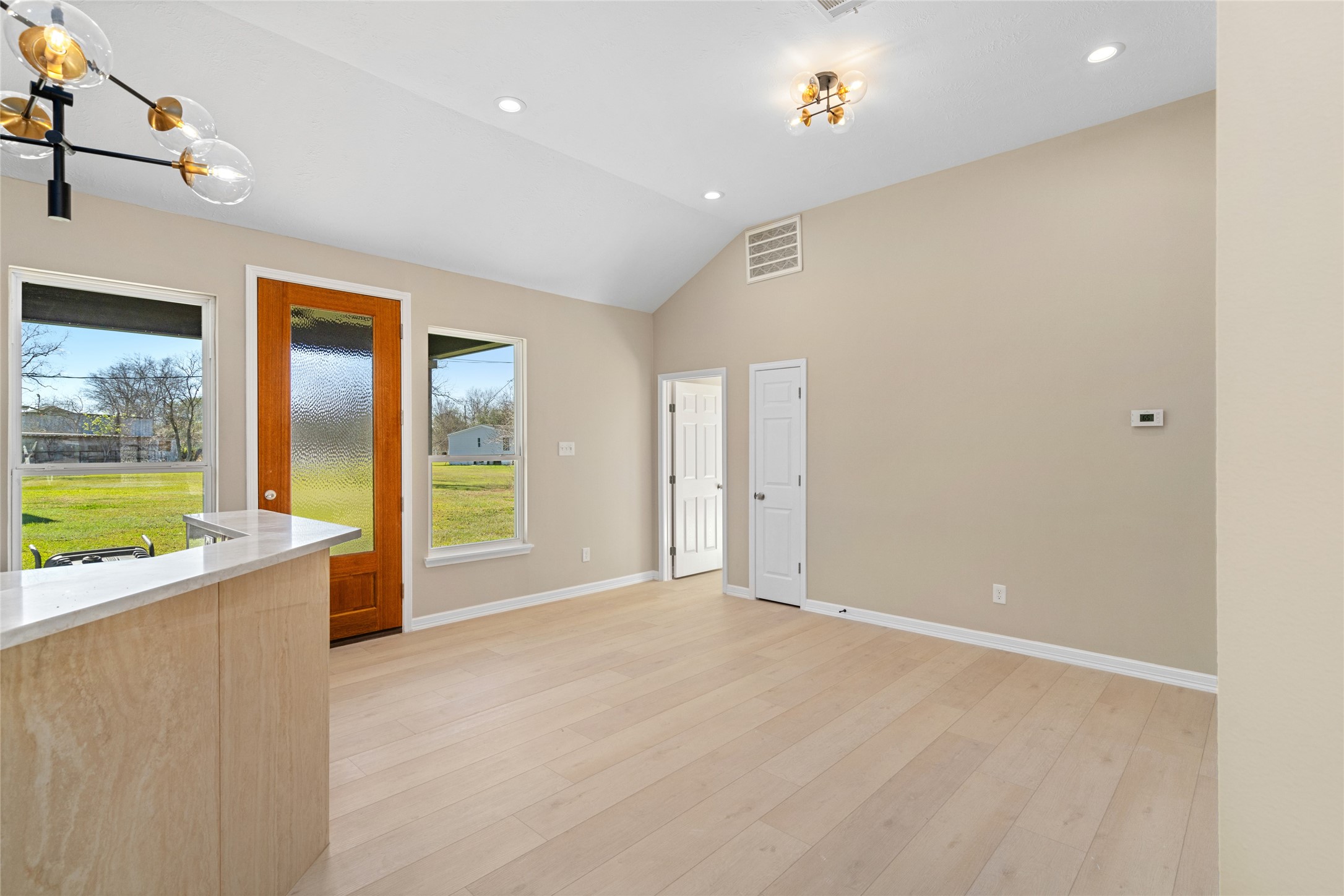 Sunlight streams through
multiple windows,
illuminating the dining nook
and offering picturesque
views of the lush backyard,
ideal for indoor-outdoor
living.