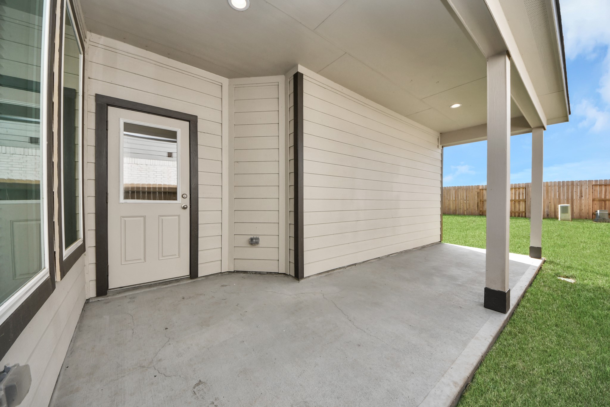 Experience outdoor living at its finest on this expansive covered patio, thoughtfully designed for BBQs and delightful outdoor dining. Sample photo of completed home with similar floor plan. Actual colors and selections may vary.