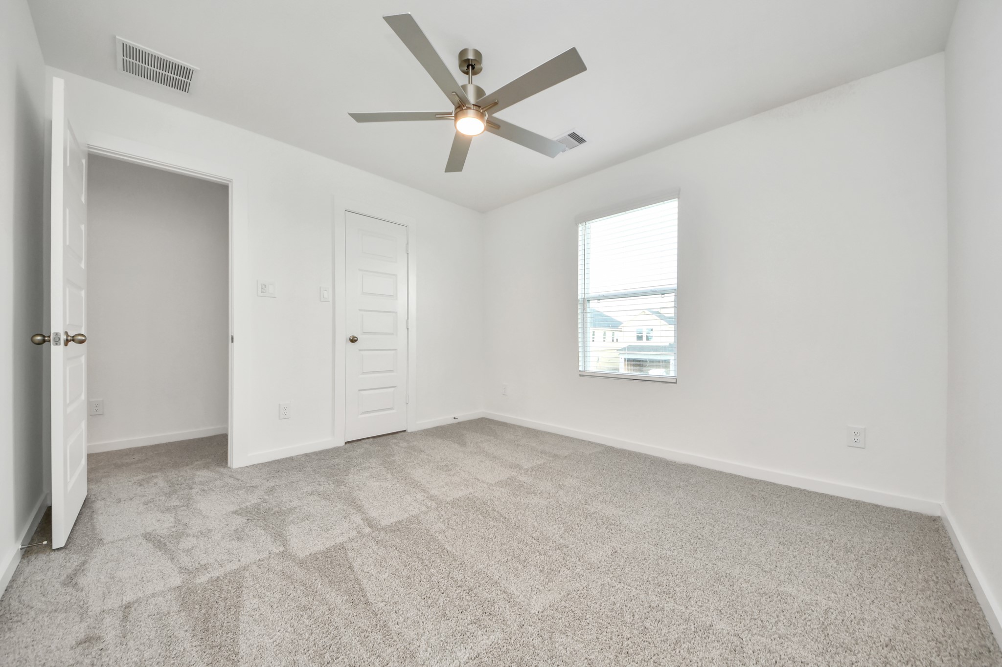 Generously sized secondary bedrooms featuring spacious closets, soft and inviting carpeting underfoot, large windows allowing plenty of natural light, and the added touch of privacy blinds for your personal retreat. Sample photo of completed home with similar floor plan. Actual colors and selections may vary.
