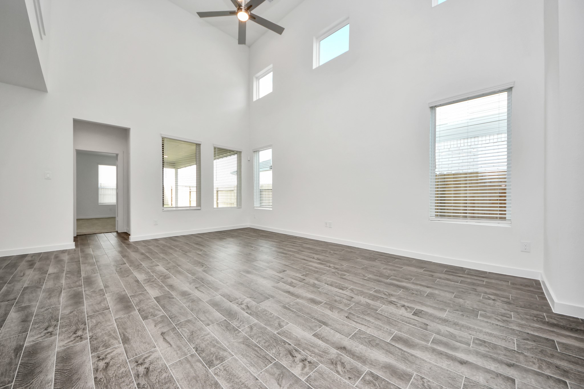 Gather the family and guests together in your lovely living room! Featuring soaring high ceilings, recessed lighting, ceiling fan, custom paint, gorgeous floors, and large windows that provide plenty of natural lighting throughout the day. Sample photo of completed home with similar floor plan. Actual colors and selections may vary. Gather the family and guests together in your lovely living room! Featuring soaring high ceilings, recessed lighting, ceiling fan, custom paint, gorgeous floors, and large windows that provide plenty of natural lighting throughout the day. Sample photo of completed home with similar floor plan. Actual colors and selections may vary.