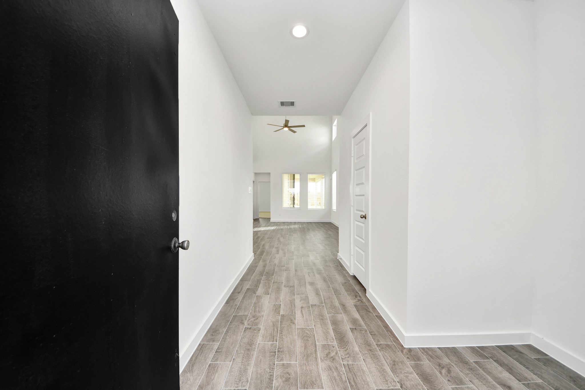 As you step into the threshold of this luxurious home, you'll soon be welcomed by an elegant glass door (to be installed). Inside, soaring ceilings amplify the spaciousness, while the refined wood-look tile flooring and oversized baseboards exude sophistication and charm. Sample photo of completed home with similar floor plan. Actual colors and selections may vary. As you step into the threshold of this luxurious home, you'll soon be welcomed by an elegant glass door (to be installed). Inside, soaring ceilings amplify the spaciousness, while the refined wood-look tile flooring and oversized baseboards exude sophistication and charm. Sample photo of completed home with similar floor plan. Actual colors and selections may vary.