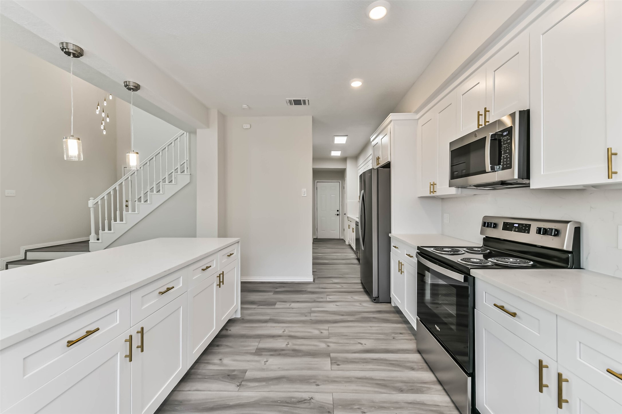 There is a GE built-in microwave, Whirlpool electric oven/range and a Whirlpool refrigerator.