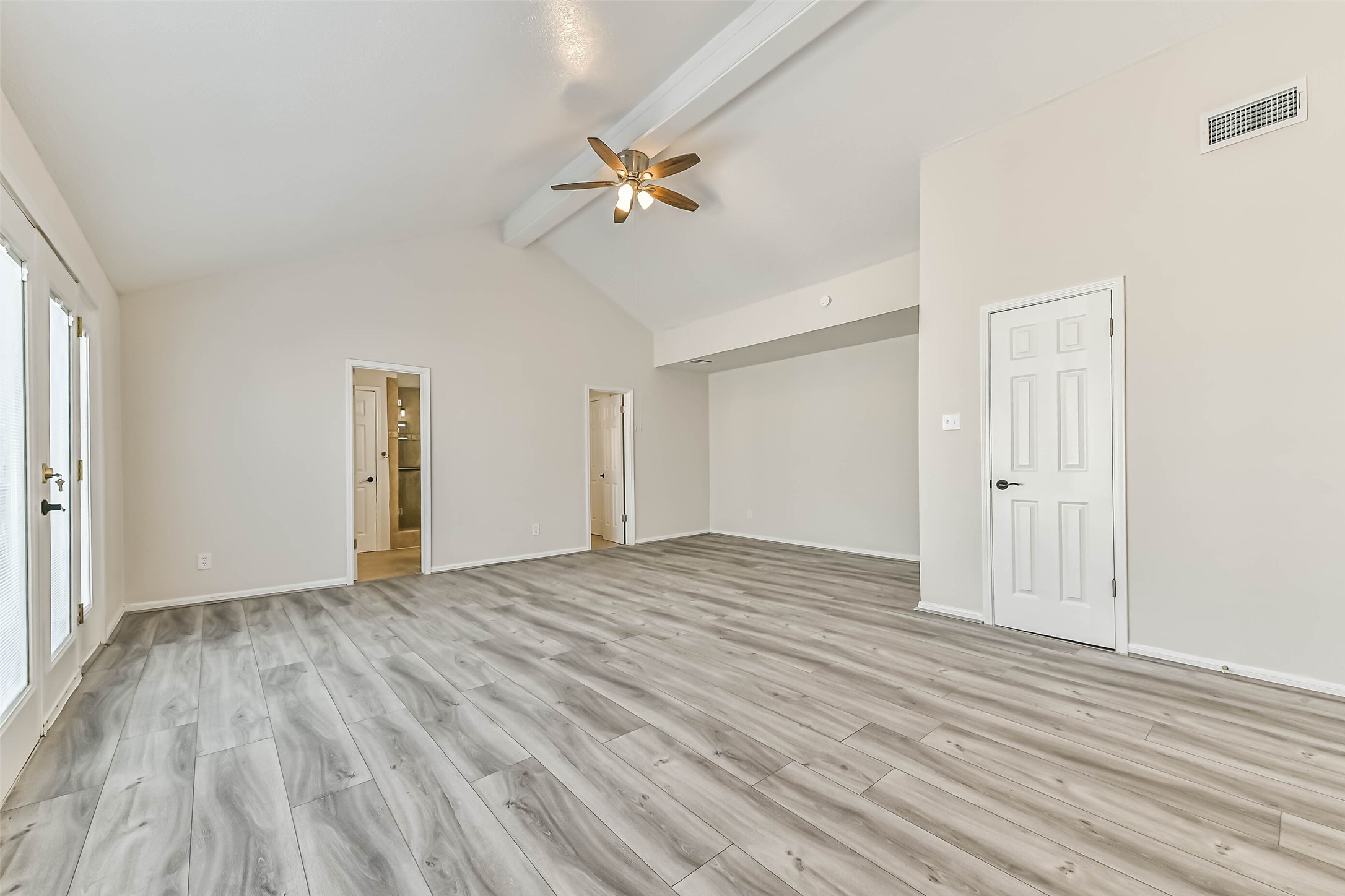 Upstairs, the primary bedroom is very spacious with luxury vinyl plank floors, high ceilings, a ceiling fan, three closets and access to the private balcony!