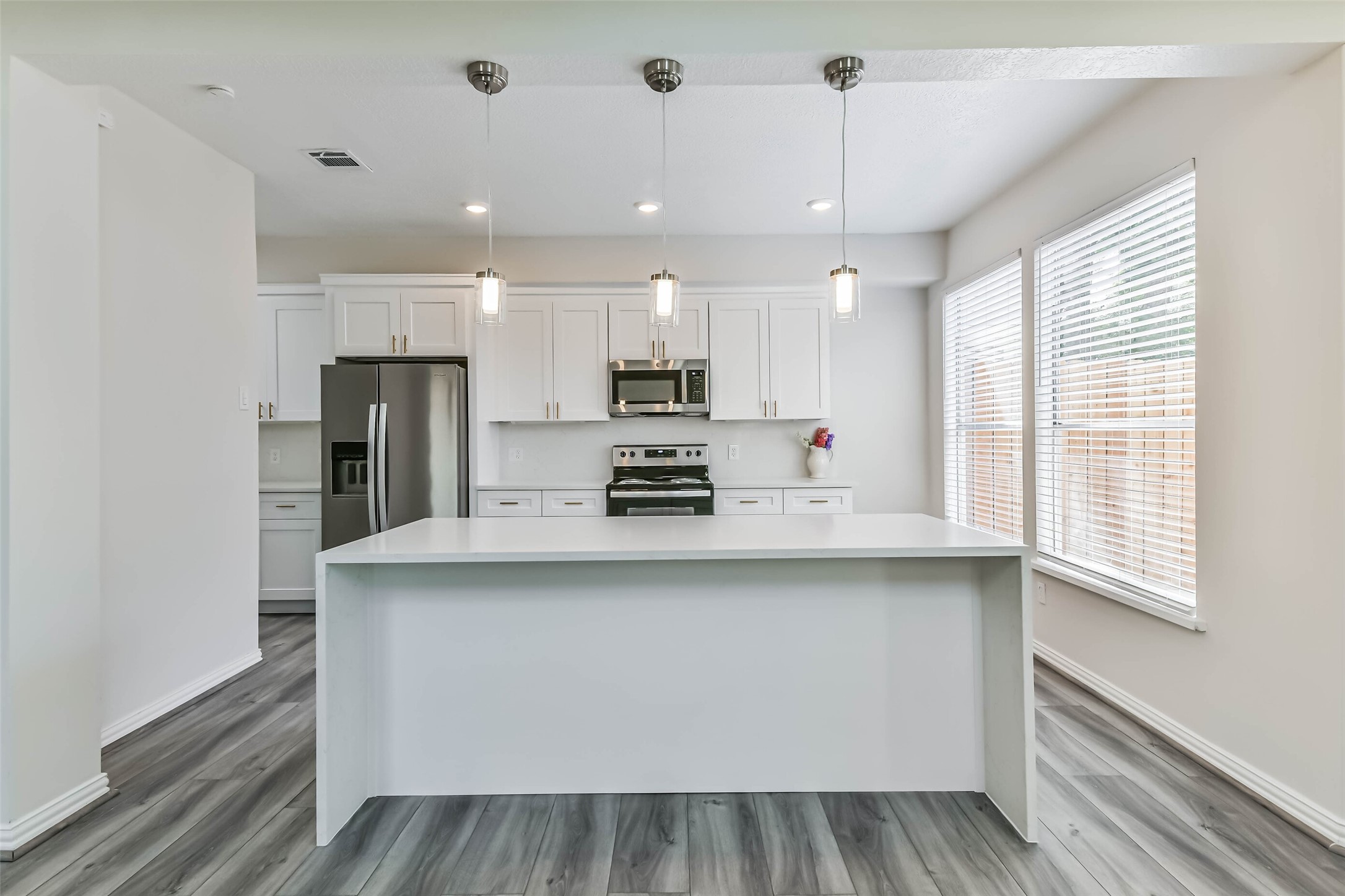 The kitchen features quartz counters, updated shaker style cabinetry with gold fixtures, stainless steel appliances and LED recessed lighting. The kitchen features quartz counters, updated shaker style cabinetry with gold fixtures, stainless steel appliances and LED recessed lighting.