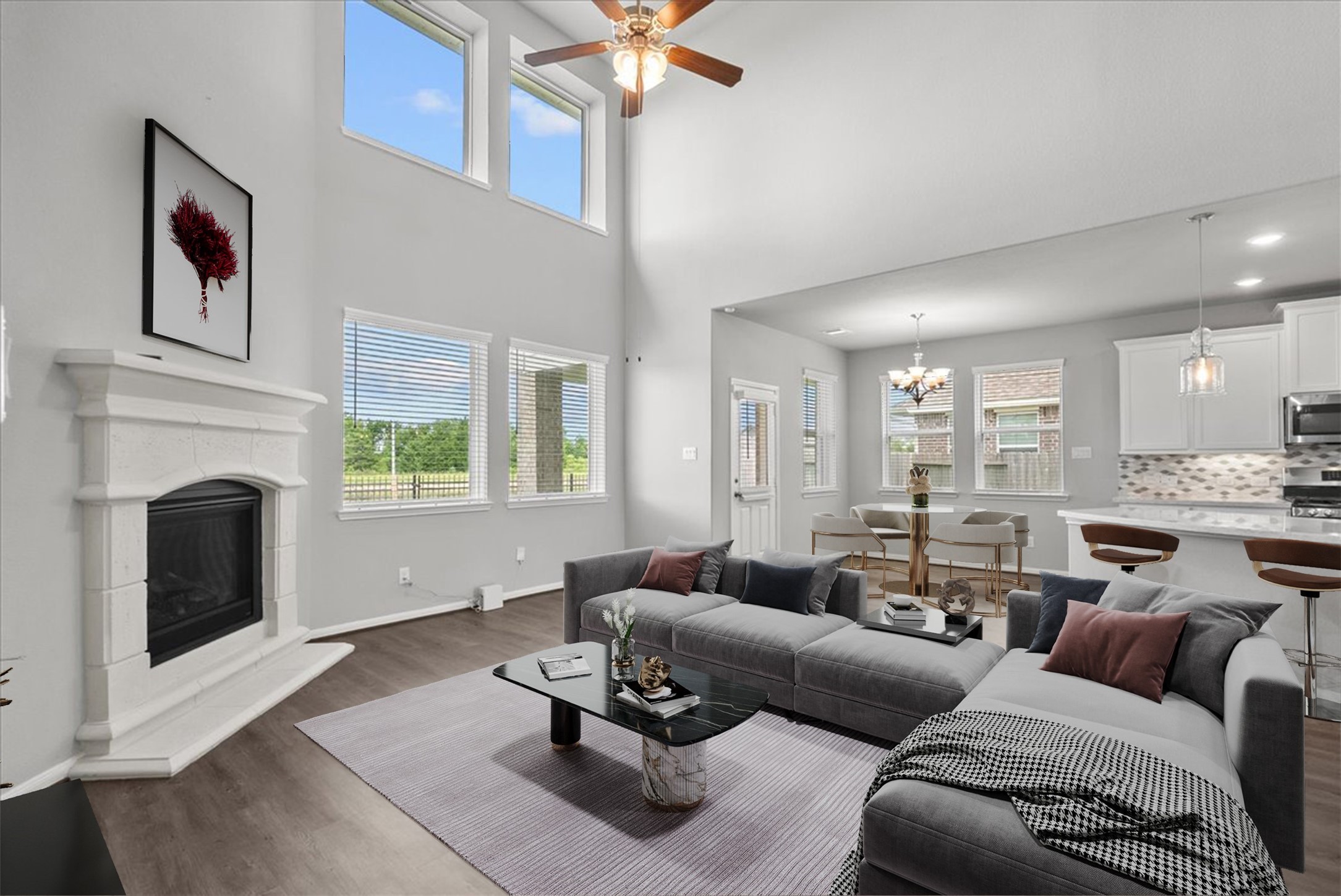 Living room features two-story ceilings and a cozy fireplace for those cold winter nights