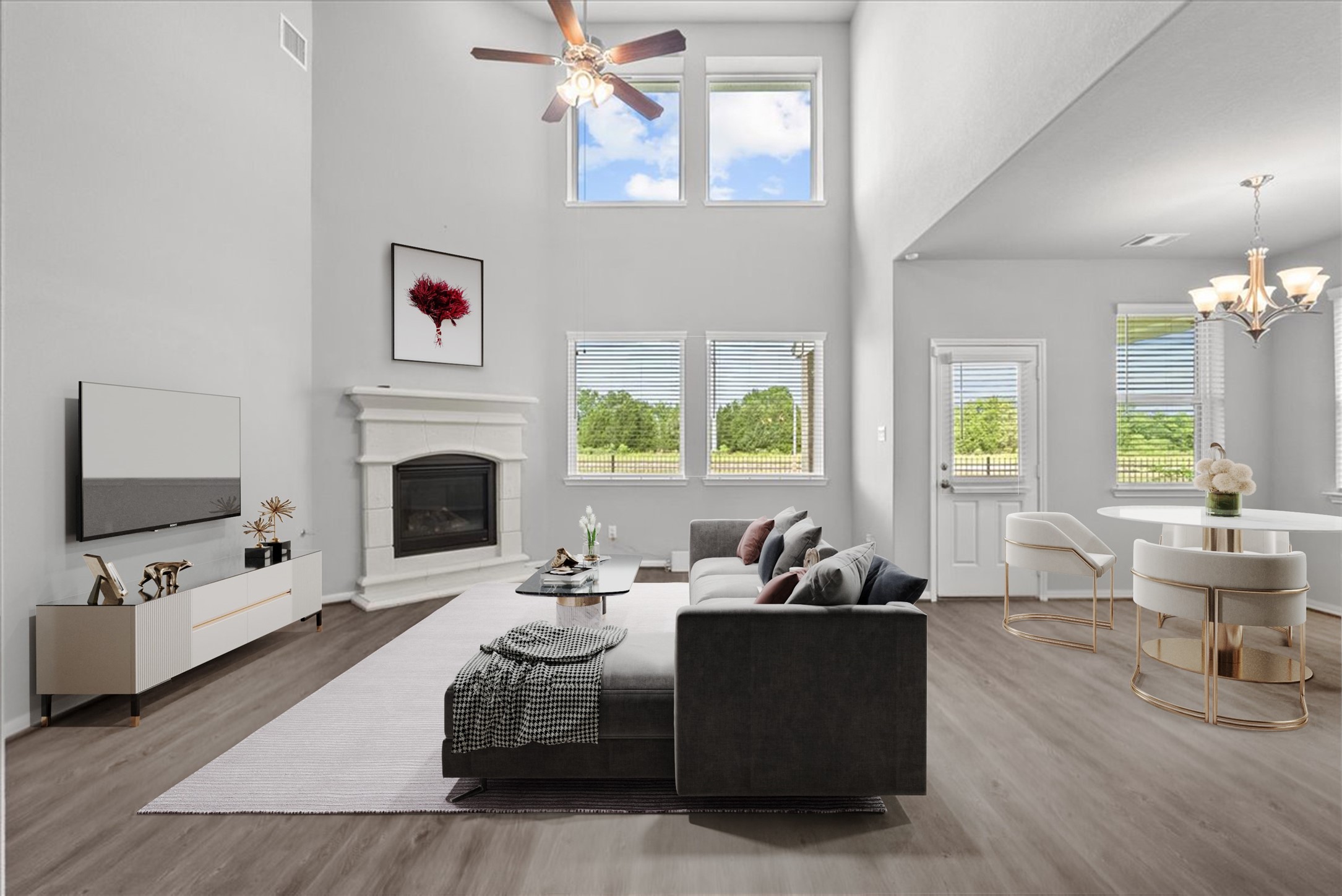 Living room features two-story ceilings and a cozy fireplace for those cold winter nights