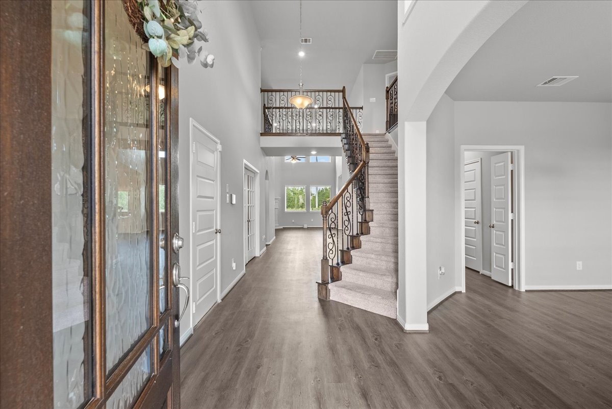 Enter from a covered front porch to soaring ceilings