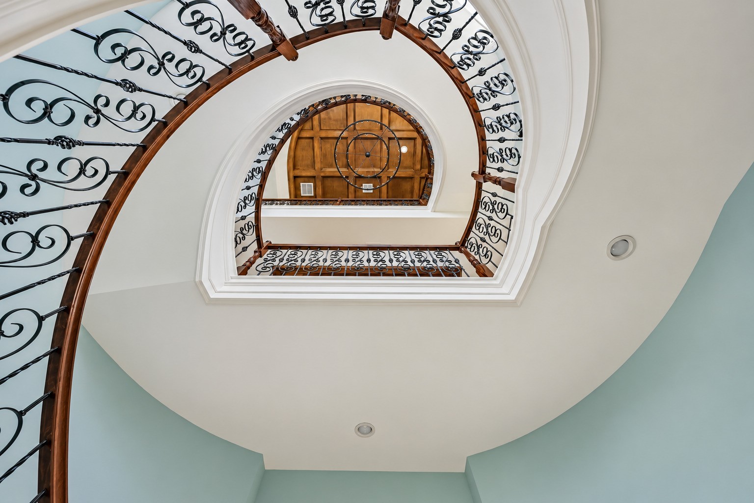 Step through the front door and look up. A soaring three-story foyer opens above you, flooded with natural light and anchored by one of the most dramatic architectural features in all of Harborwalk  an elegantly curved staircase that rises through every level of the home. This is the moment buyers remember.