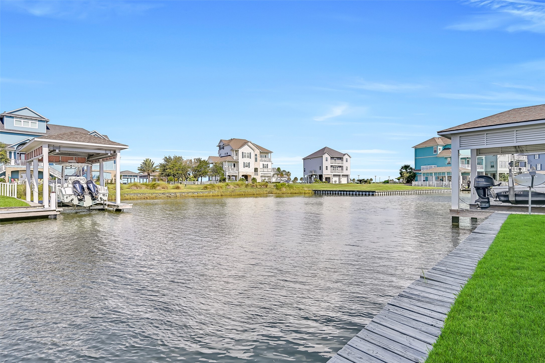 This is the view that sells itself. Looking down the canal at 12 Fleming, you see exactly what waterfront living on the Texas Gulf Coast is meant to look like  a private boathouse with a 30-foot electric lift, a fully rebuilt dock, lush landscaping, and a stunning three-story home rising above the water behind it. The Flamingo Isles MUD maintains the bulkheads and canal depths so the water stays navigable year round. From this angle, it is easy to understand why buyers who discover Harborwalk rarely look a