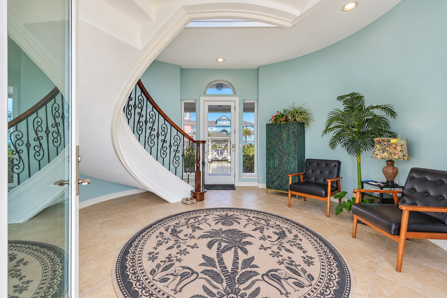 Hand-crafted and one of a kind. The ornate curved staircase at 12 Fleming features stained rail tops and threshold work that ties seamlessly into the wide-plank flooring and coffered ceilings above. A wrought iron chandelier overhead completes the picture. This is the kind of craftsmanship you expect in a luxury custom build  because that is exactly what this is.