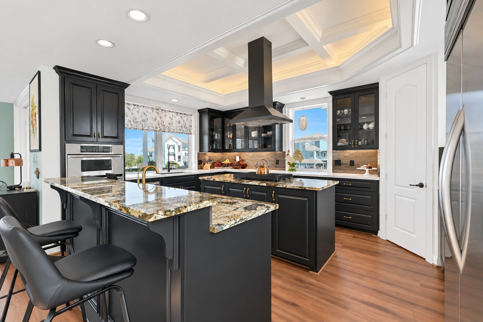 Dual Brazilian granite islands, custom under-lit cabinetry, and a commercial KitchenAid refrigerator  this kitchen was built to entertain. Every detail is custom, everything is updated.