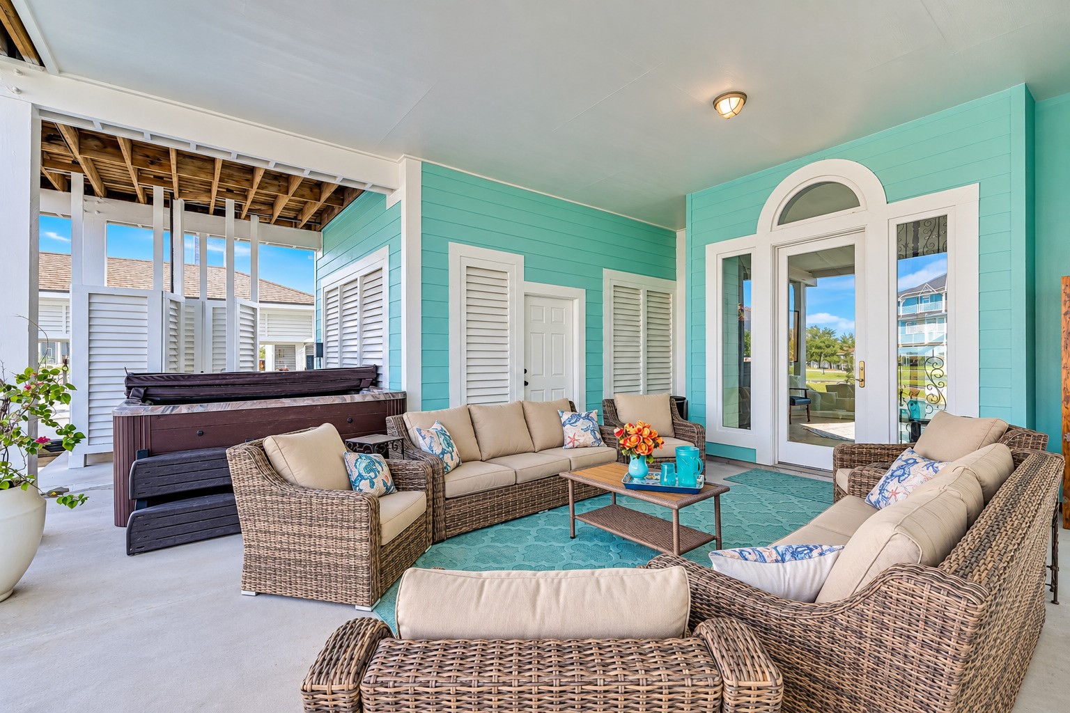 The outdoor living does not stop at the water's edge. The expansive covered lower patio at 12 Fleming is fully furnished and every piece stays with the home  just move in and start living. An 8-person Sunbelt hot tub, outdoor shower, and direct dockside access make this the hub of Gulf Coast entertaining. Watch the boats pass, listen to the water, and host the kind of gatherings this space was made for. Everything is here. Everything is new. All you have to do is show up.