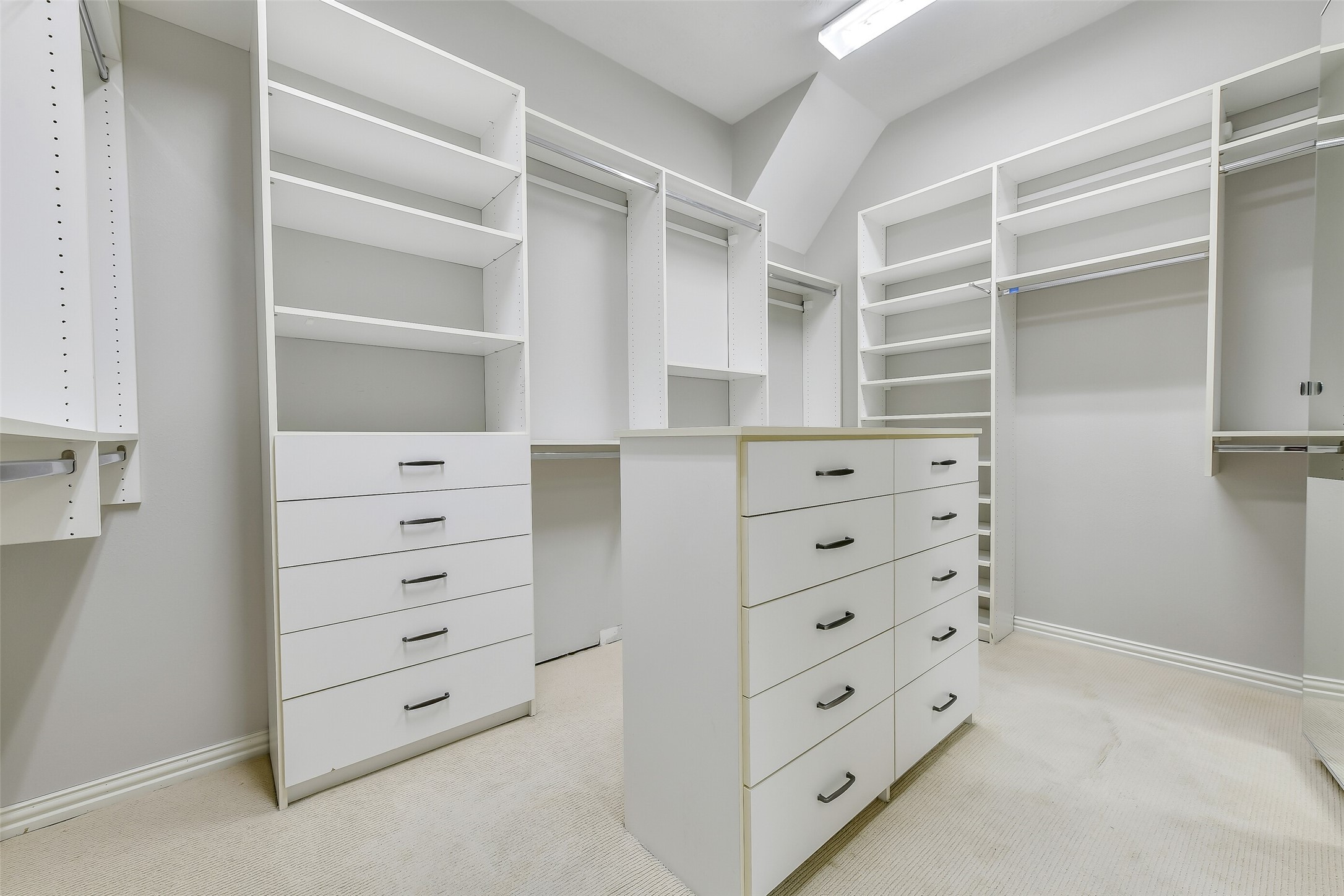 The oversized primary closet features custom California Closet upgrades with built-in storage and drawers, freeing up valuable floor space in the bedroom.