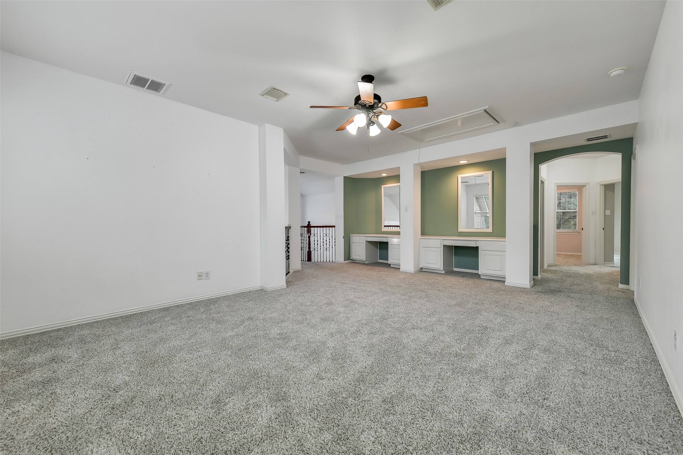 The spacious upstairs game room offers two built-in study areas for children, complete with an eye-catching accent wall.