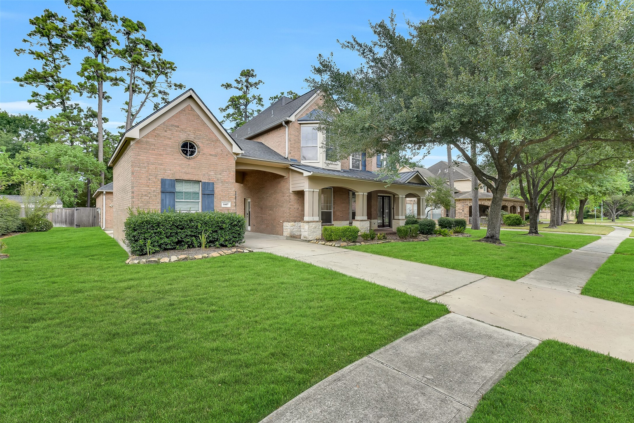 Located near the Golf Club of Houston, this home features mature trees, a two-car attached oversized garage, plus an additional single-car garage ideal for golf cart storage, alongside ample guest parking.