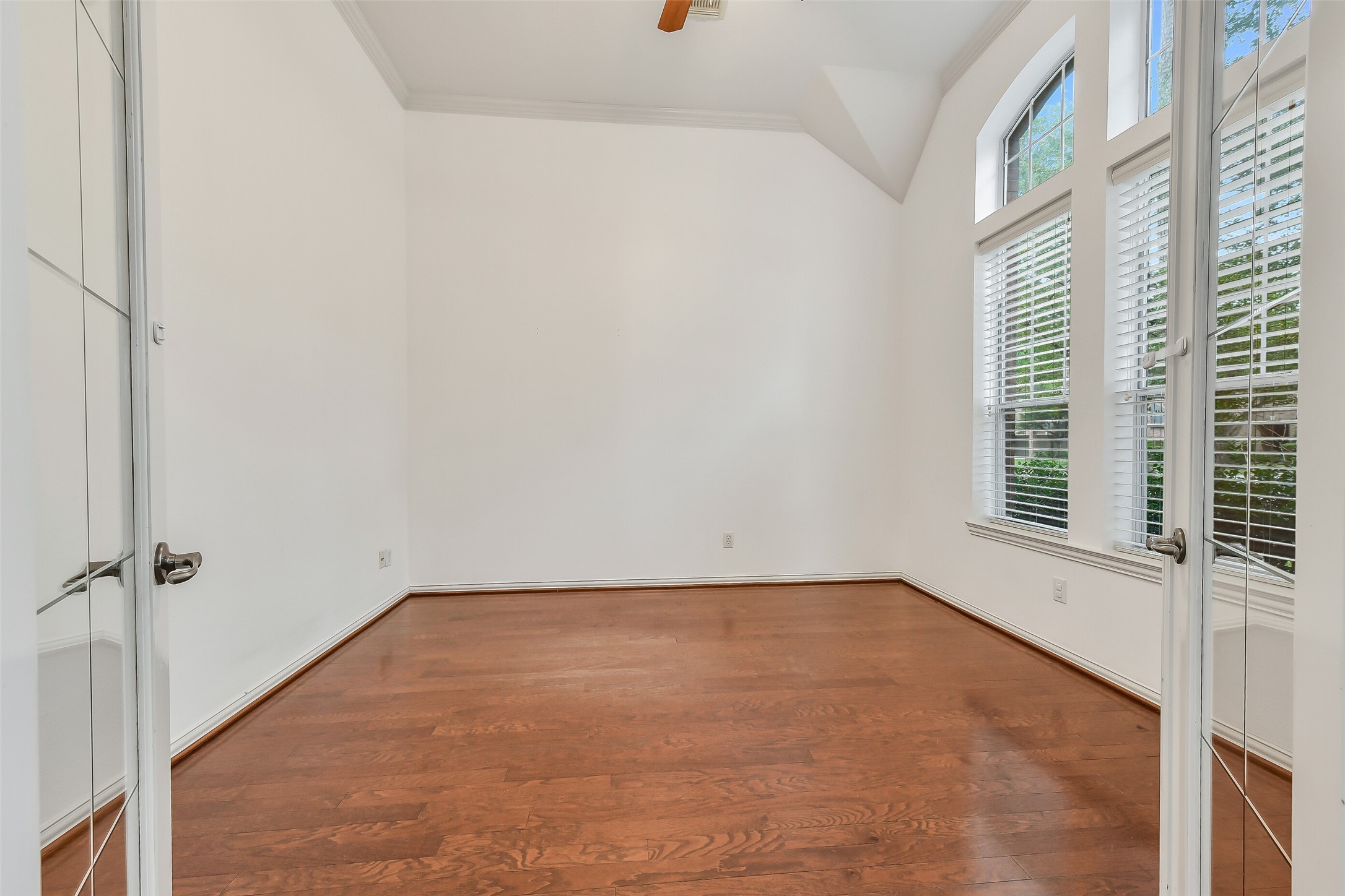 French doors provide privacy to this first-floor home office overlooking the front yard.