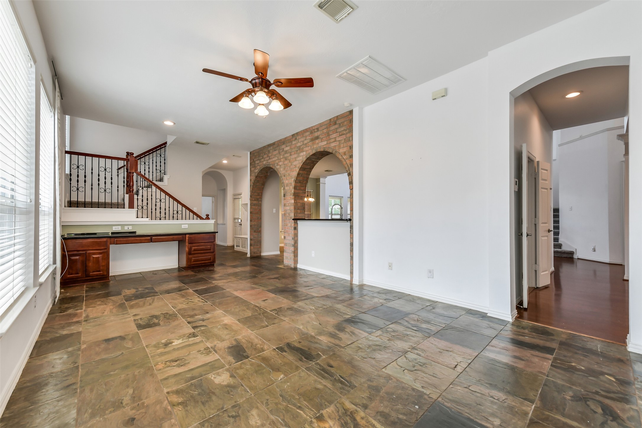 Flowing directly off the kitchen, this versatile sitting room/sunroom makes an exceptional first-floor entertaining spaceperfect for a pool table or shuffleboard along with custom built-in desk/bill pay station  A second staircase provides convenient access to the upstairs landing and game room.