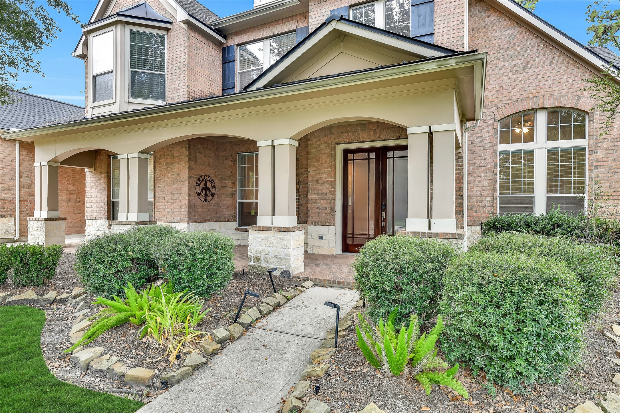 This expansive covered porch offers a wonderful outdoor space for relaxing or chatting with neighbors.
