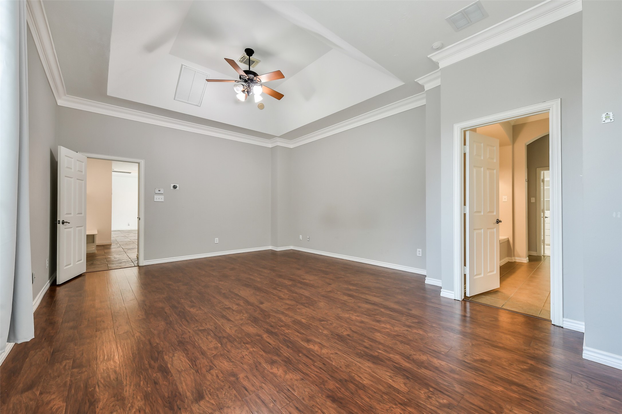 Another view of the primary suite, privately positioned at the rear of the home for ultimate peace and quiet.