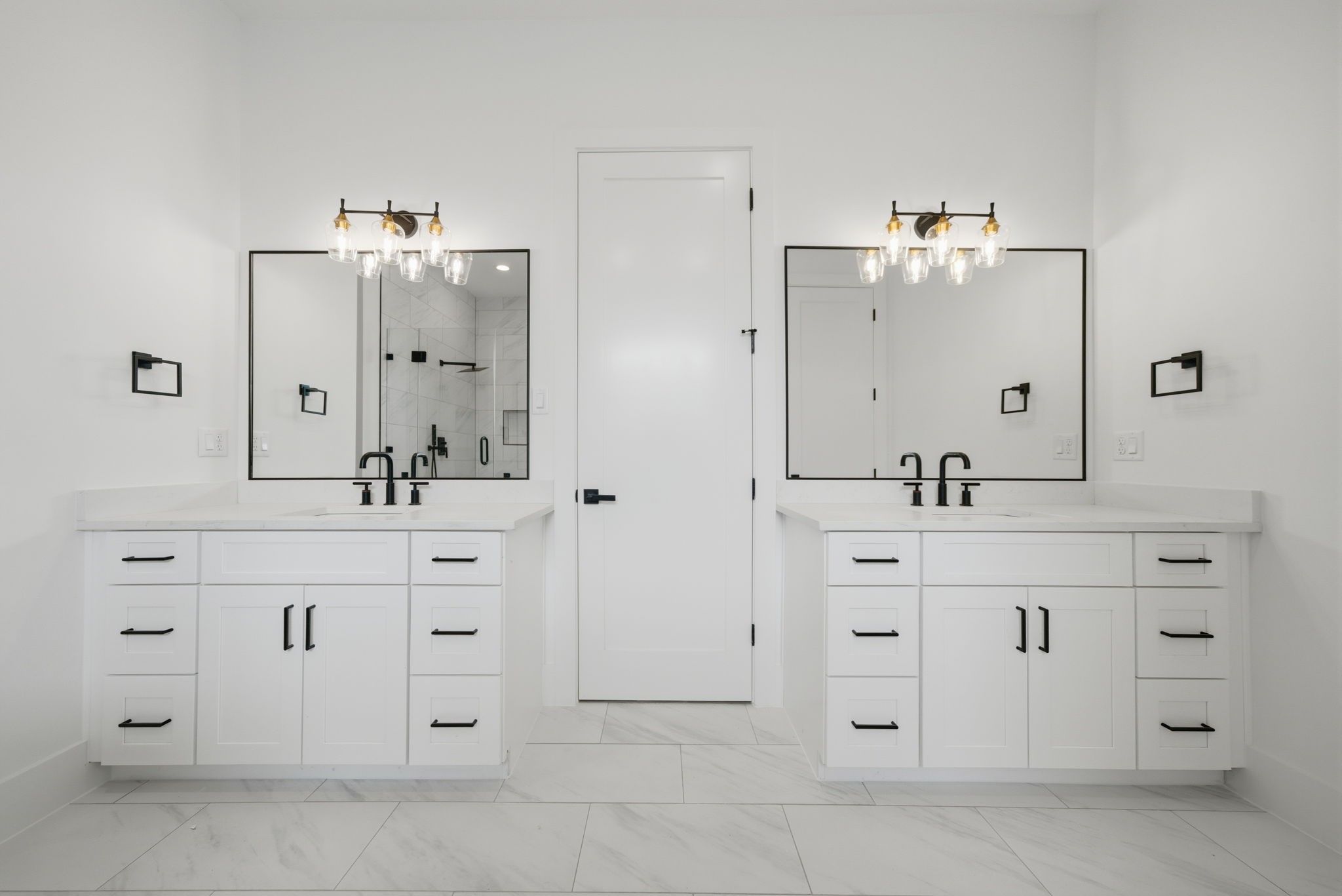 Dual vanities with quartz counters, designer fixtures, and black matte hardware. (Photos are of a previously completed home. Finishes are subject to change.)
