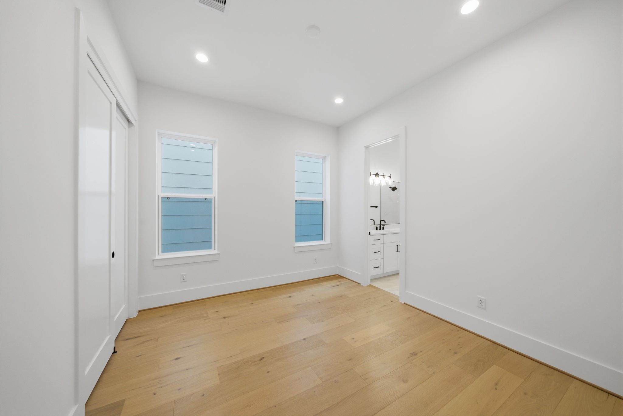 another view of the second of three secondary sizable guest bedrooms with large closet and adjoining bath. (Photos are of a previously completed home. Finishes are subject to change.)