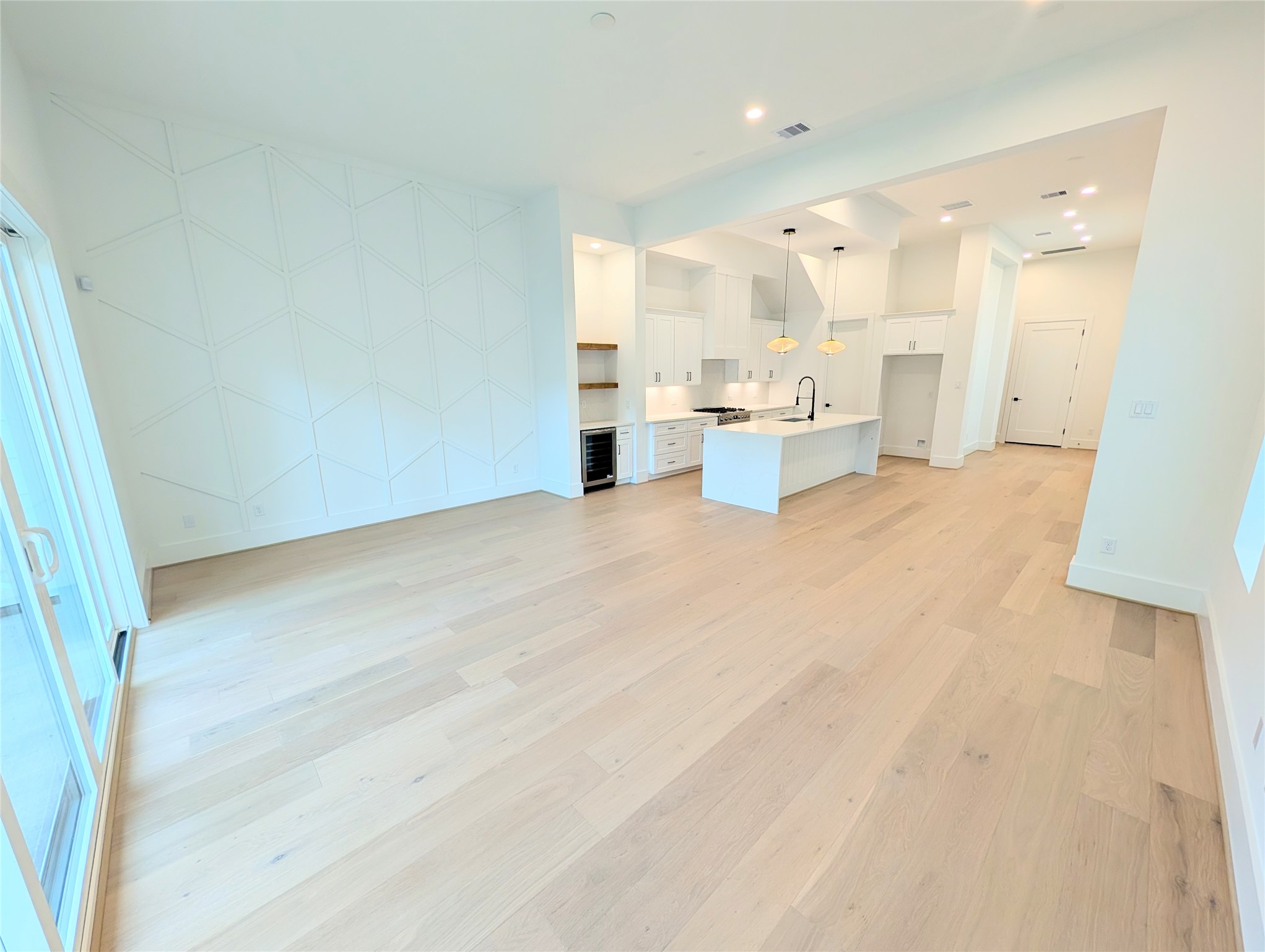 Highlighting the modern living concept, this open floor plan with 13 foot ceilings and windows. Living room open to the dining area and chef's kitchen Highlighting the modern living concept, this open floor plan with 13 foot ceilings and windows. Living room open to the dining area and chef's kitchen