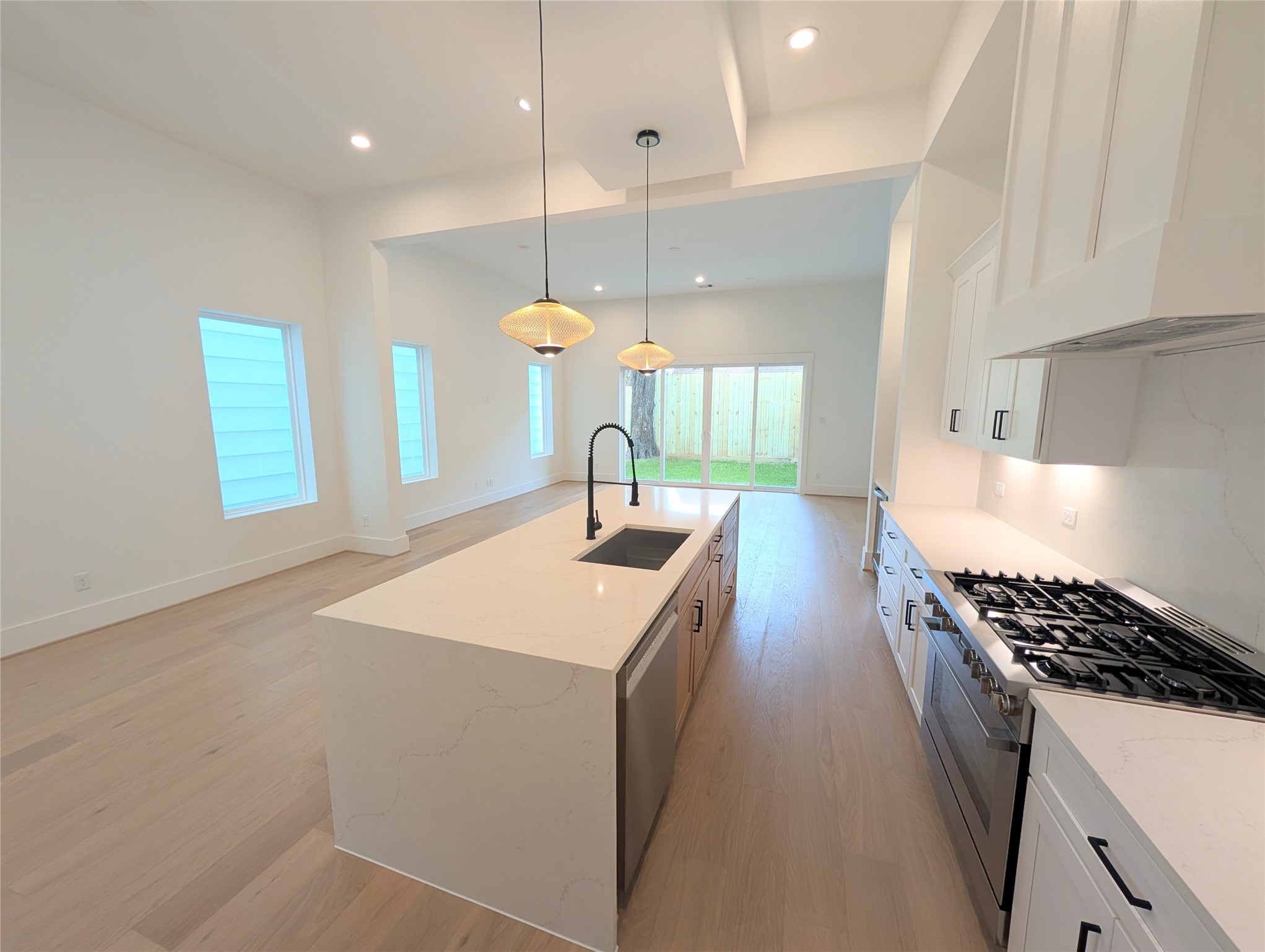 Chef's kitchen with modern open feel highlighted by Bosch appliance package all around.