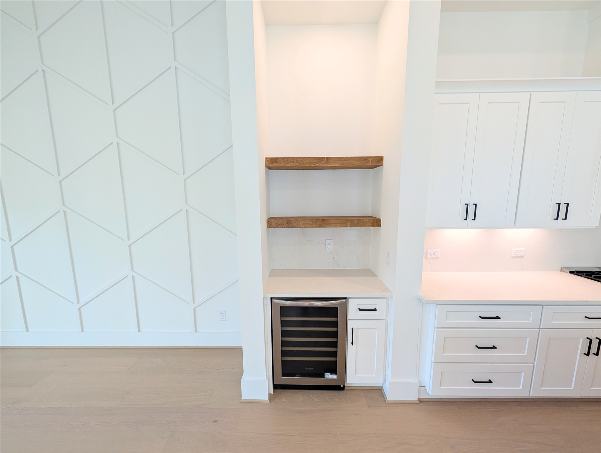 Dry bar and wine fridge are perfectly situated between the living and kitchen areas. Perfect for entertaining! Dry bar and wine fridge are perfectly situated between the living and kitchen areas. Perfect for entertaining!