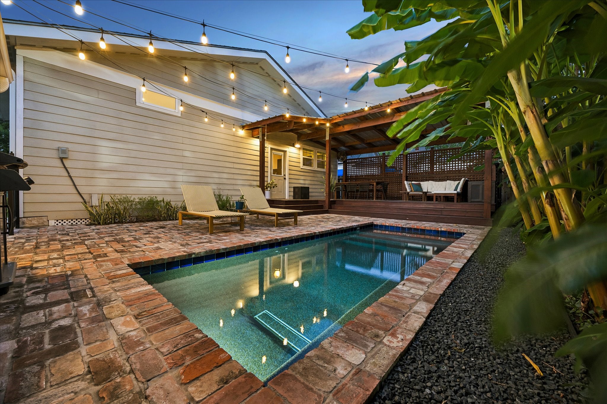 Backyard with a pool and lush landscaping