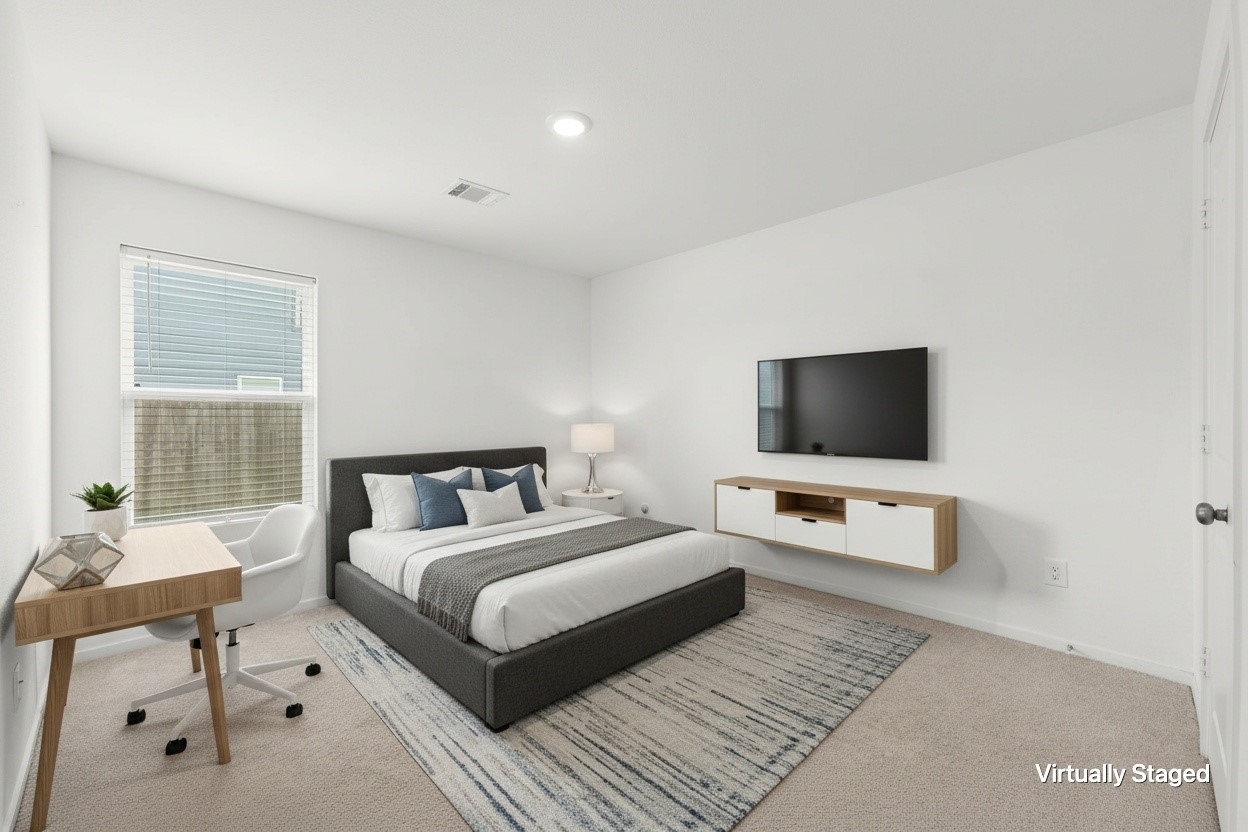Virtually staged bedroom demonstrates flexible furniture placement with space for a sleeping area, workspace, and entertainment setup.