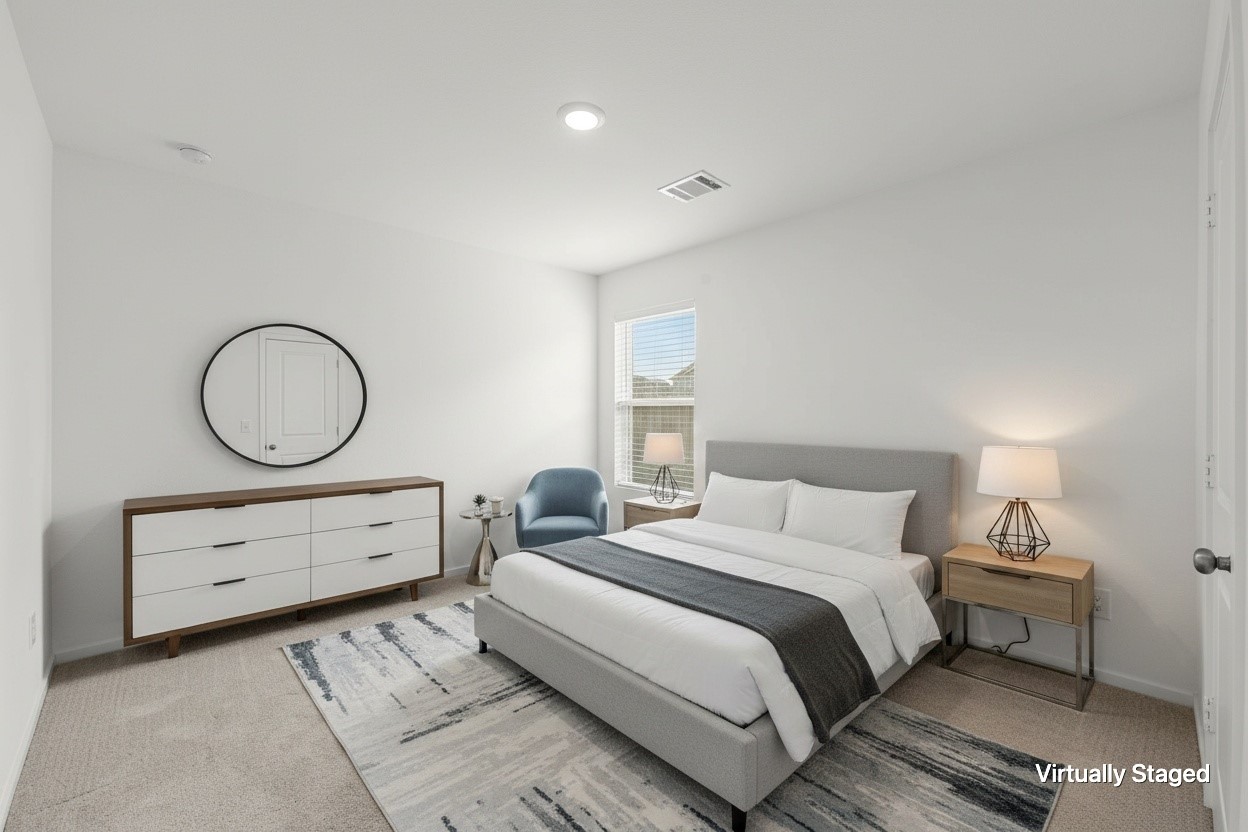 Virtually staged to showcase the bedrooms comfortable proportions, neutral carpeting, recessed lighting, and natural light from the window.