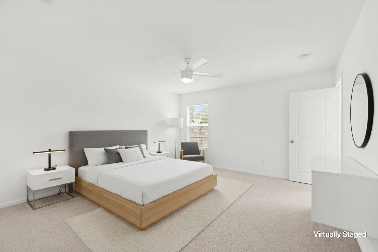 Virtually staged bedroom showcases a spacious footprint with neutral carpeting, ceiling fan, window for natural light, and room for additional furnishings.