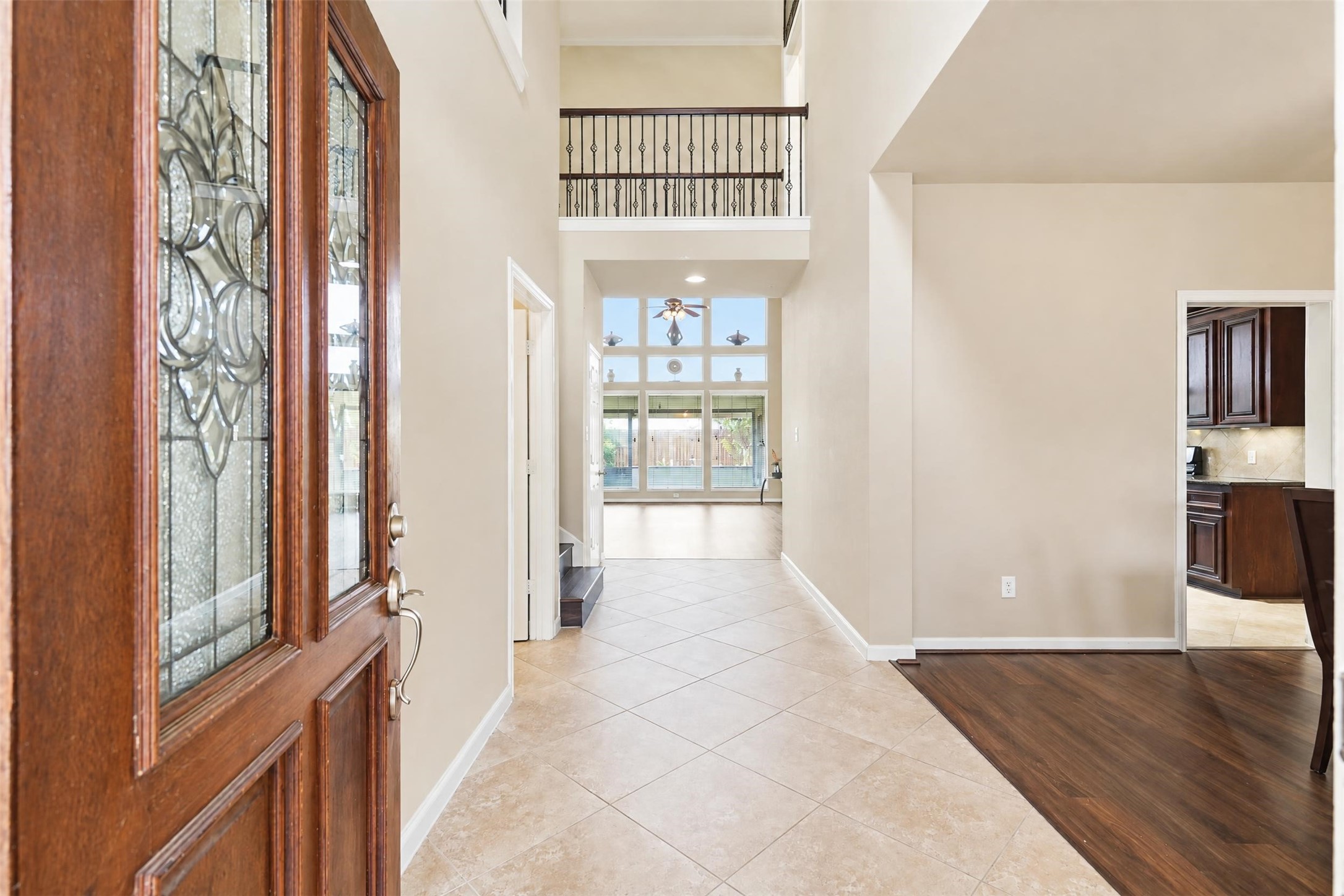 Step inside to a bright two-story entry with a leaded-glass front door, updated flooring and a clear sightline to the soaring wall of windows in the living room.