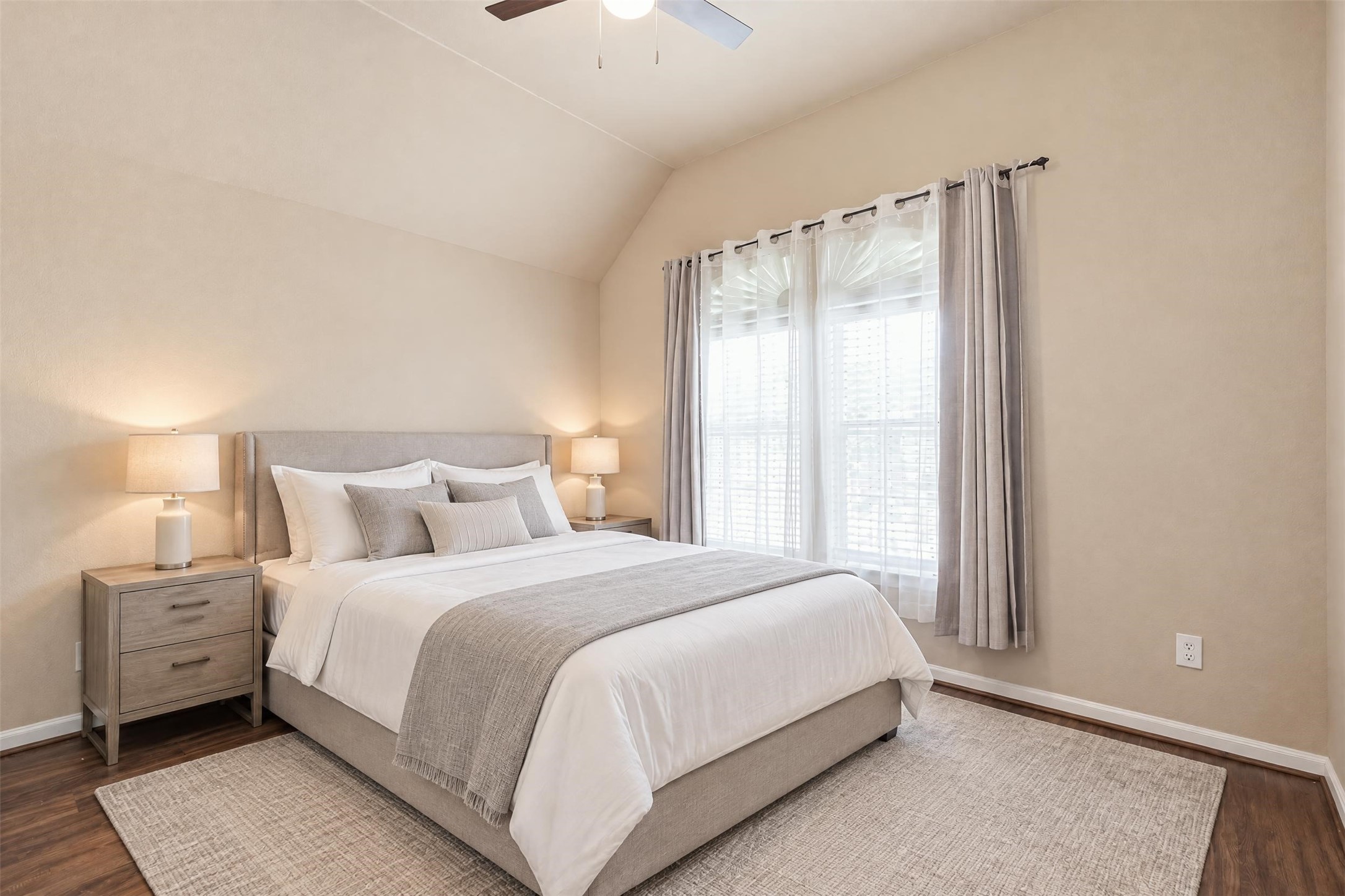 Virtually staged. The third bedroom has a vaulted ceiling and a large window that fills the room with natural light.