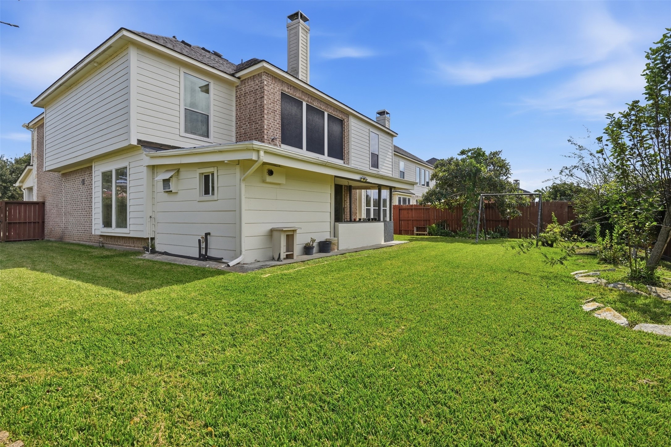 Fully fenced, with open green space beyond, so there are no neighbors directly behind you.