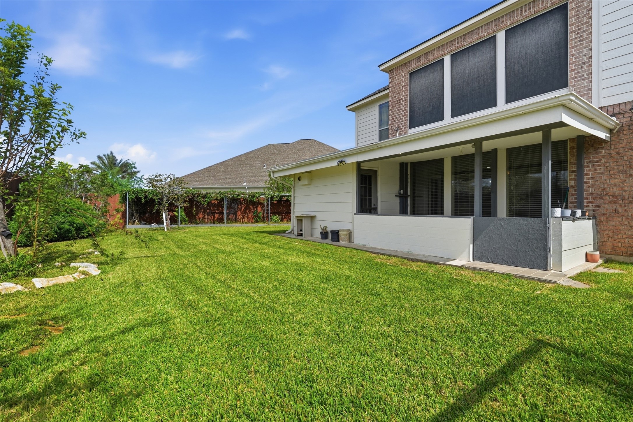 A big private backyard with mature landscaping, plenty of lawn to play, garden or entertain, and sprinklers to keep it green.