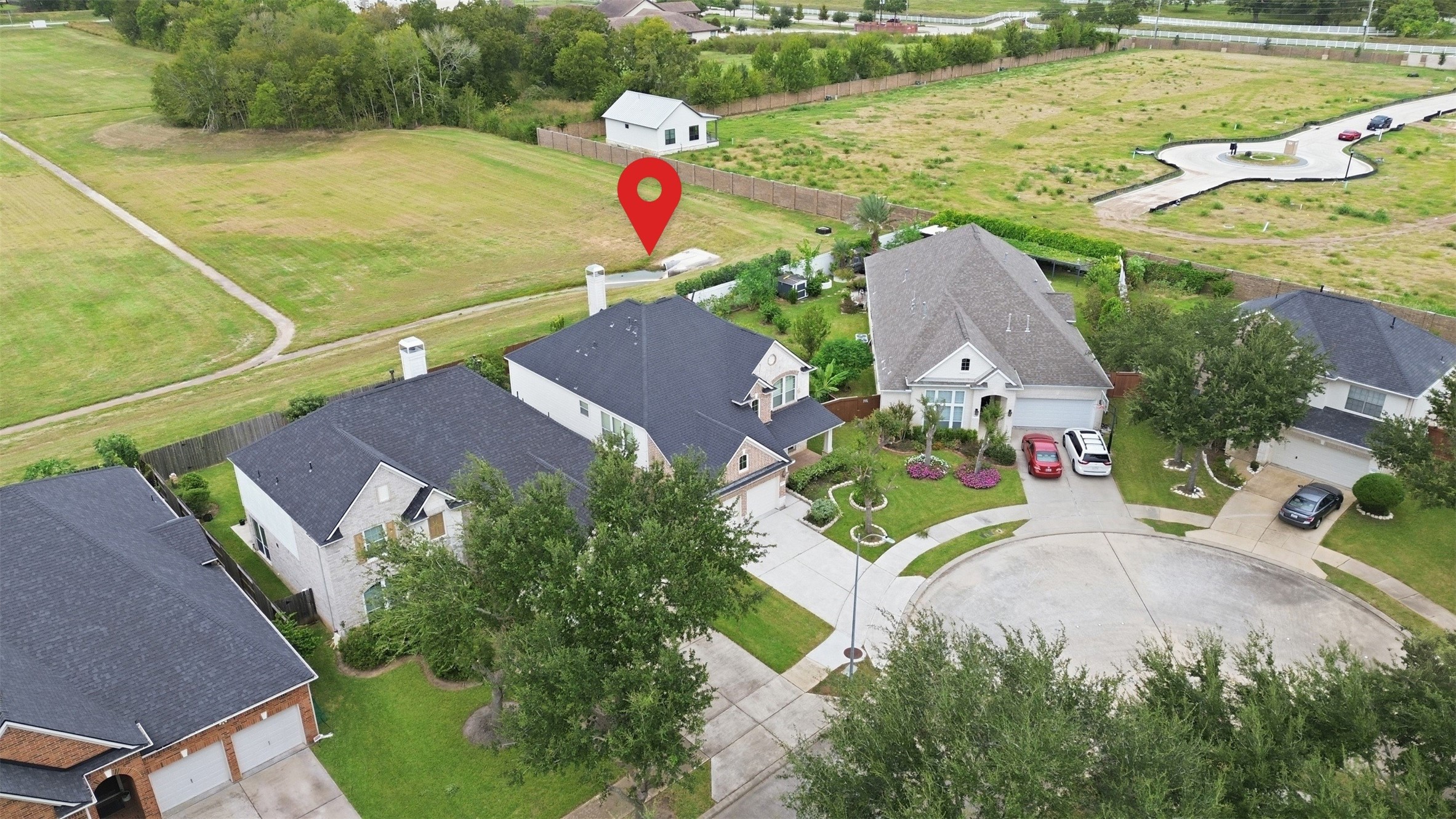 The pin marks the home on its quiet cul-de-sac, with the open green space and walking path just beyond the back fence.