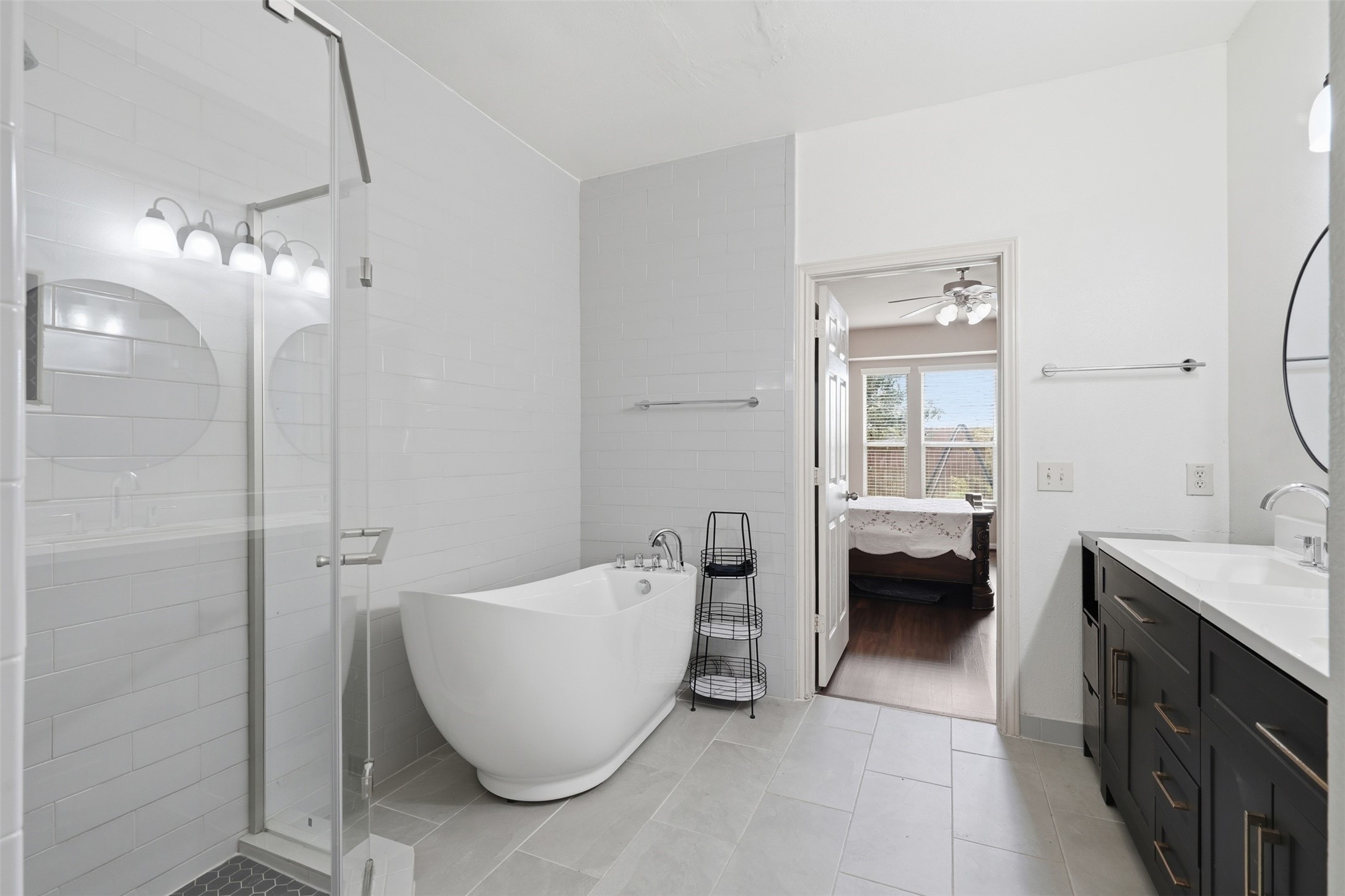 Bright tile, a freestanding tub for slow evenings and a walk-in glass shower for busy mornings. A bath that is fully updated and ready to enjoy.