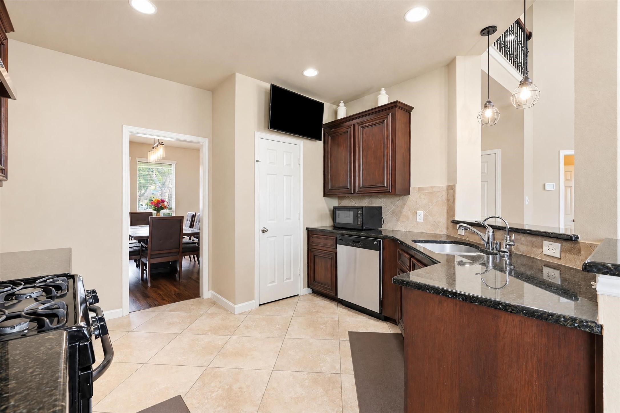 Plenty of cabinet and counter space for meal prep and storage, with a direct path to the formal dining room for easy serving.
