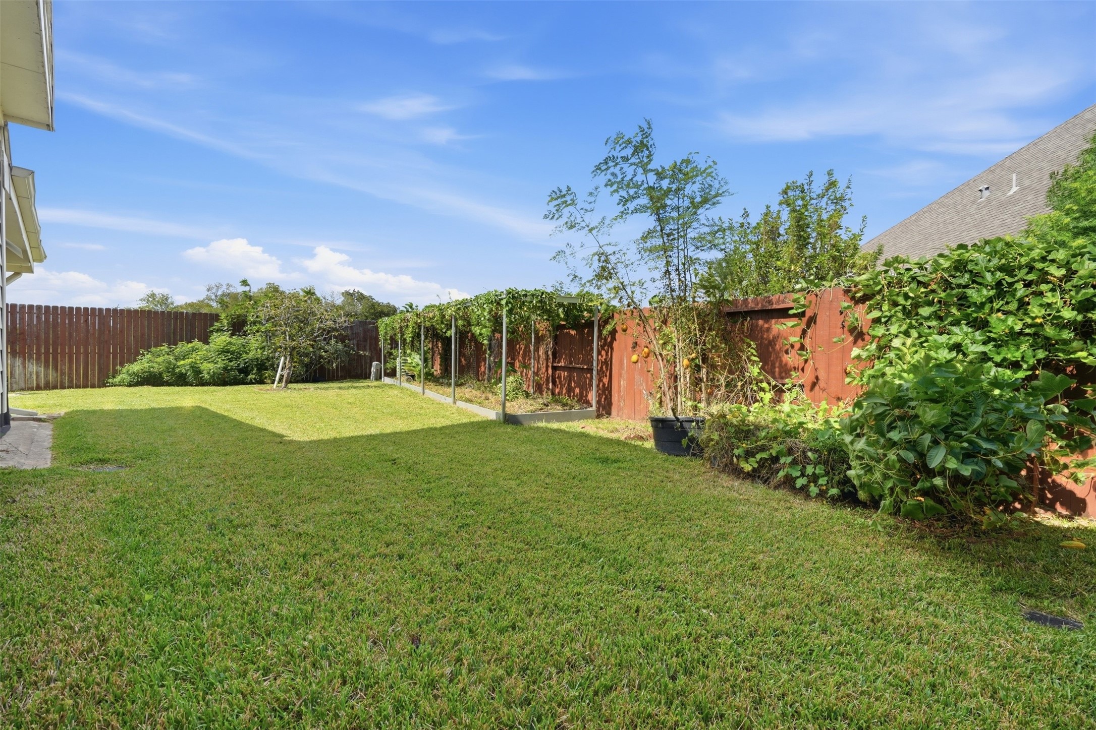Room for a play set, garden beds or a future pool, with the rear of the home showing its well-kept brick exterior.
