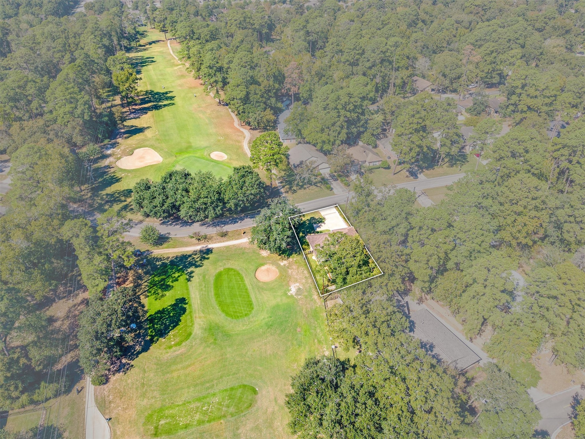 And THERE it is: the 16th tee box sits right next door, with the fairway stretching out toward the green, giving you a front-row seat to every round played here.