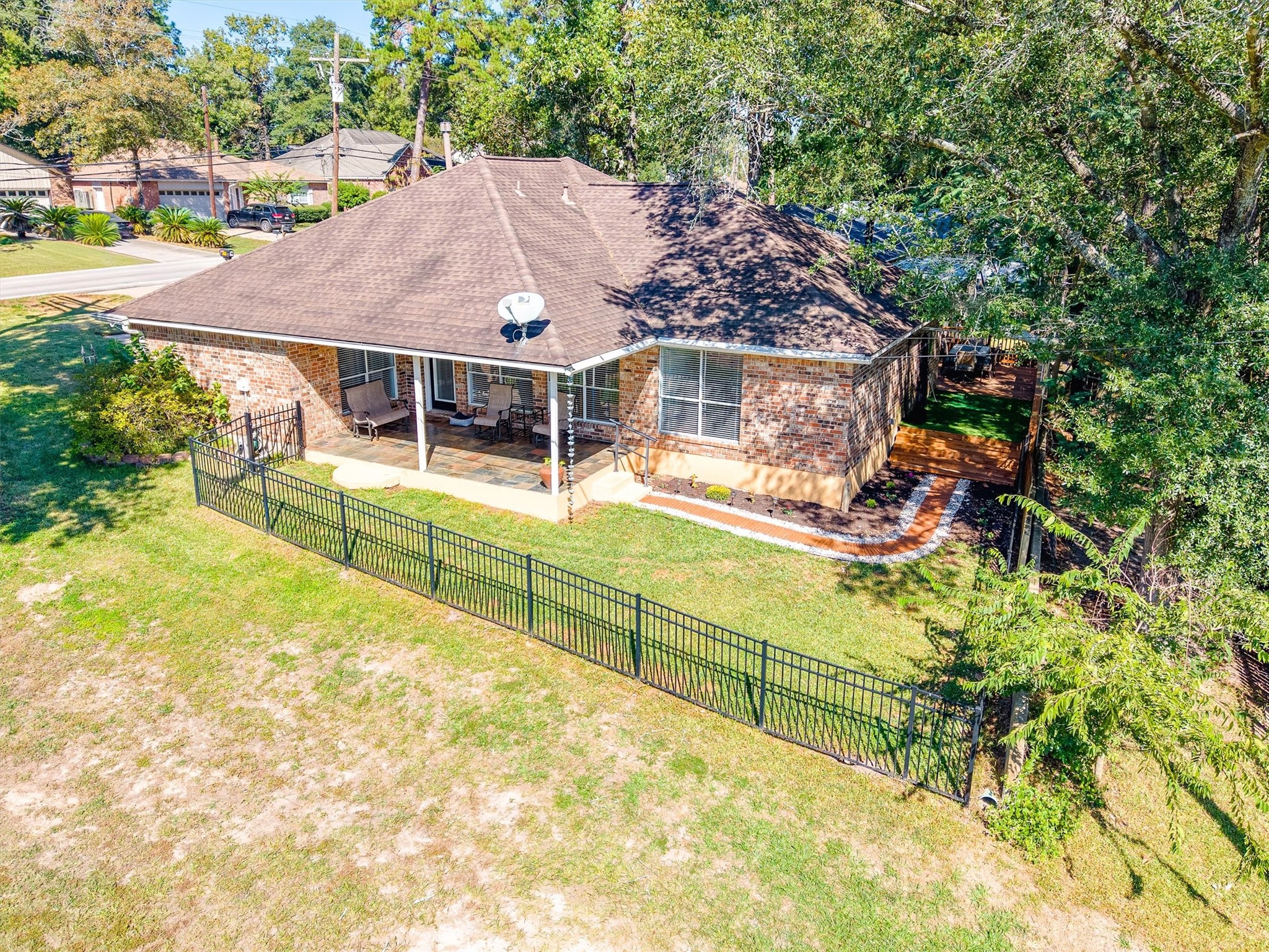 From above, you can see how the home sits right on the course, with a black iron fence lining the yard so the fairway view stays open while the backyard stays yours.
