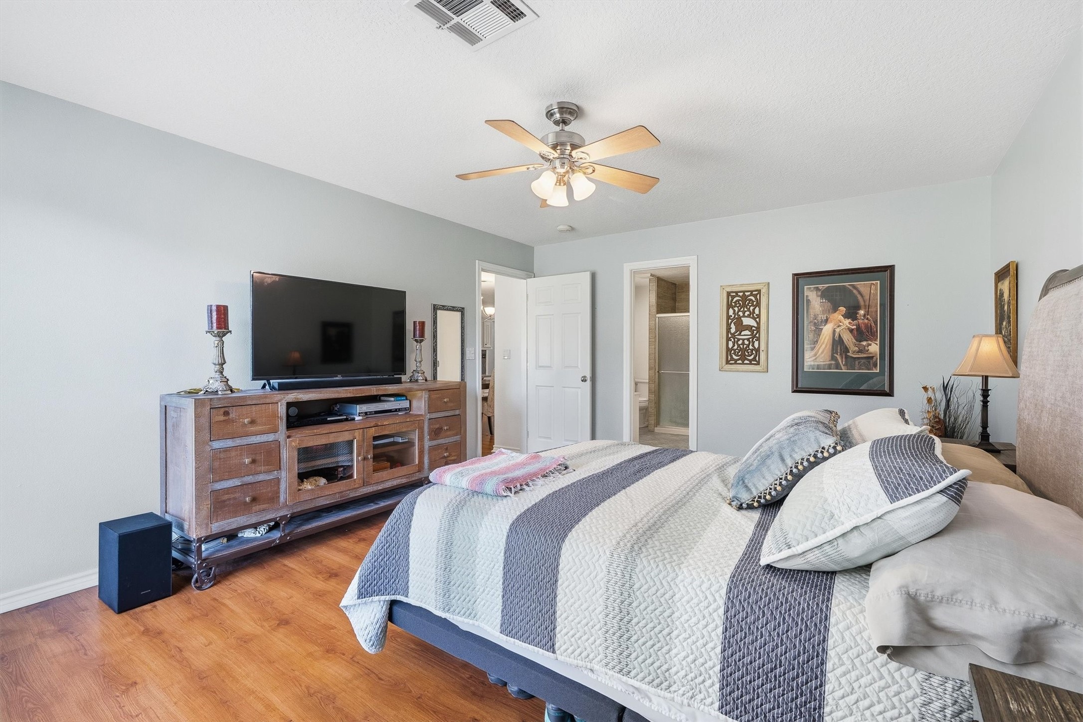 Thanks to the split floor plan, the primary suite gets its own private wing, with the ensuite bath just through the door.