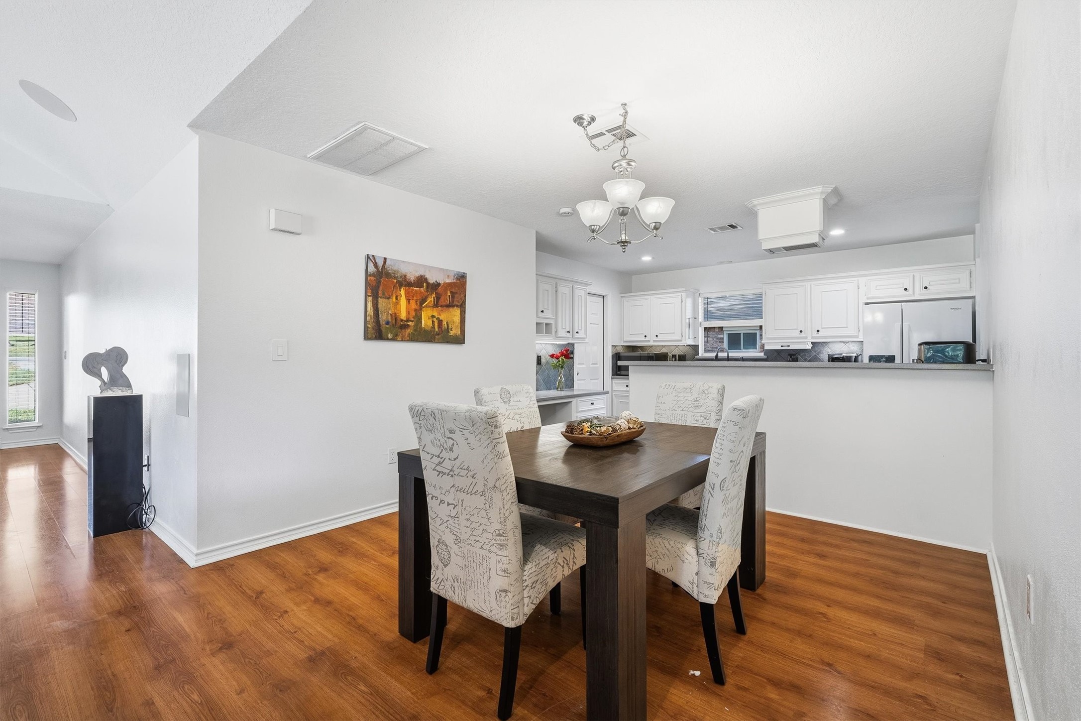 The dining area sits right off the kitchens breakfast bar, which makes serving dinner as easy as passing a plate.