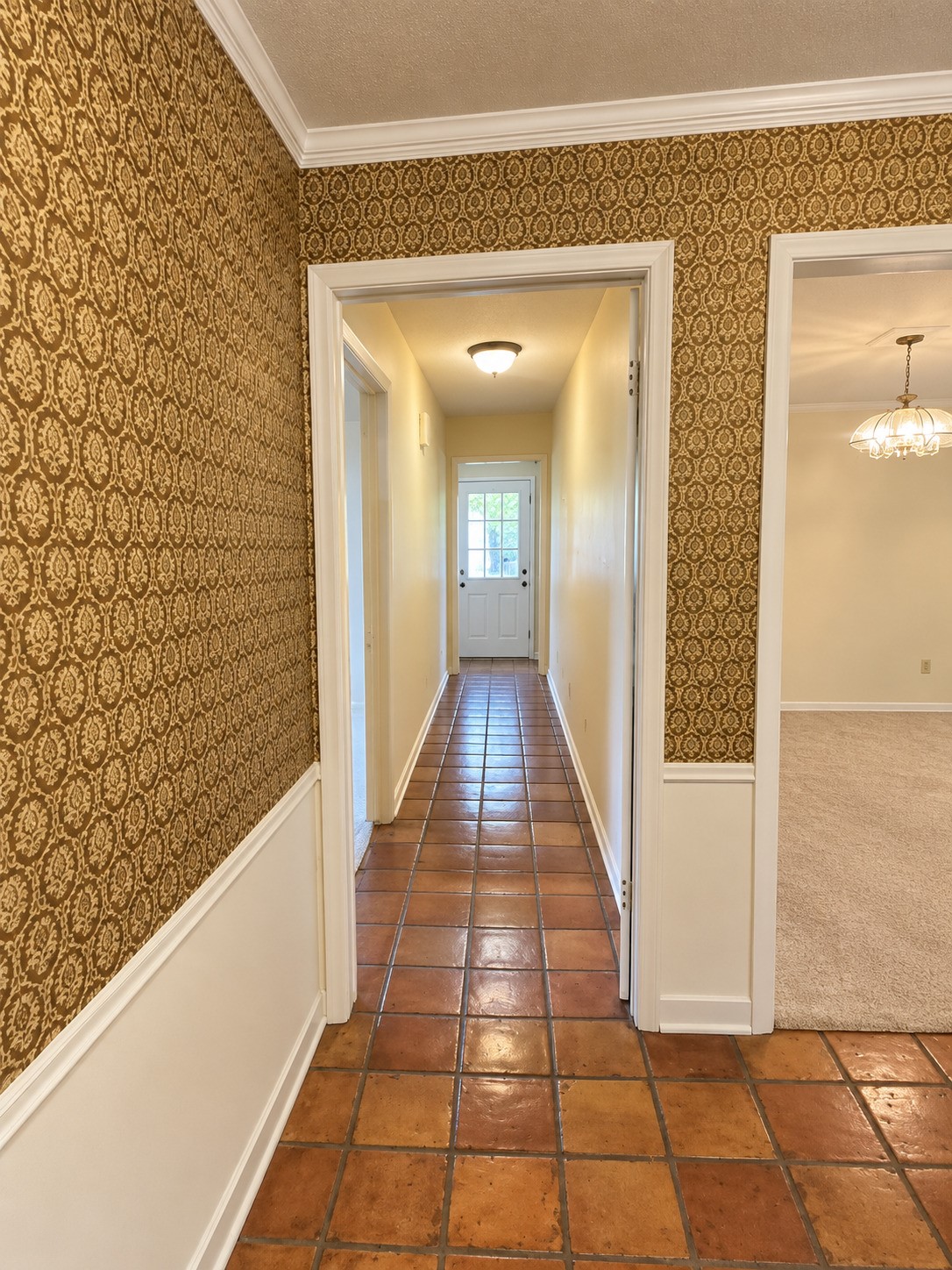 Hallway off of entrance leading to living room.
