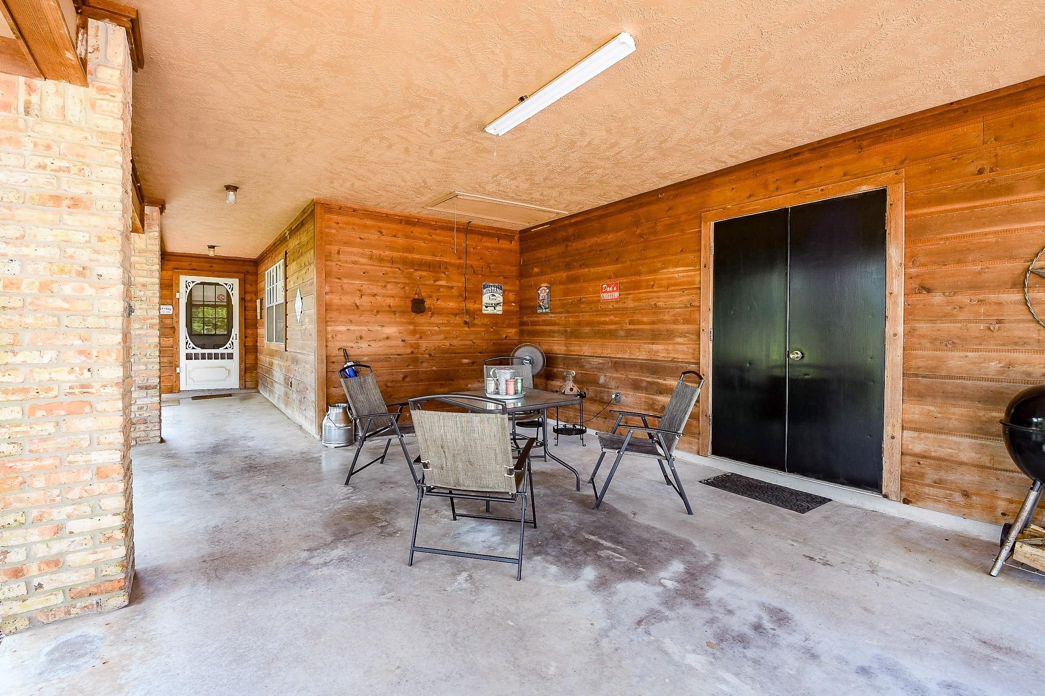 Immense covered porch in the secondary house with a storage closet