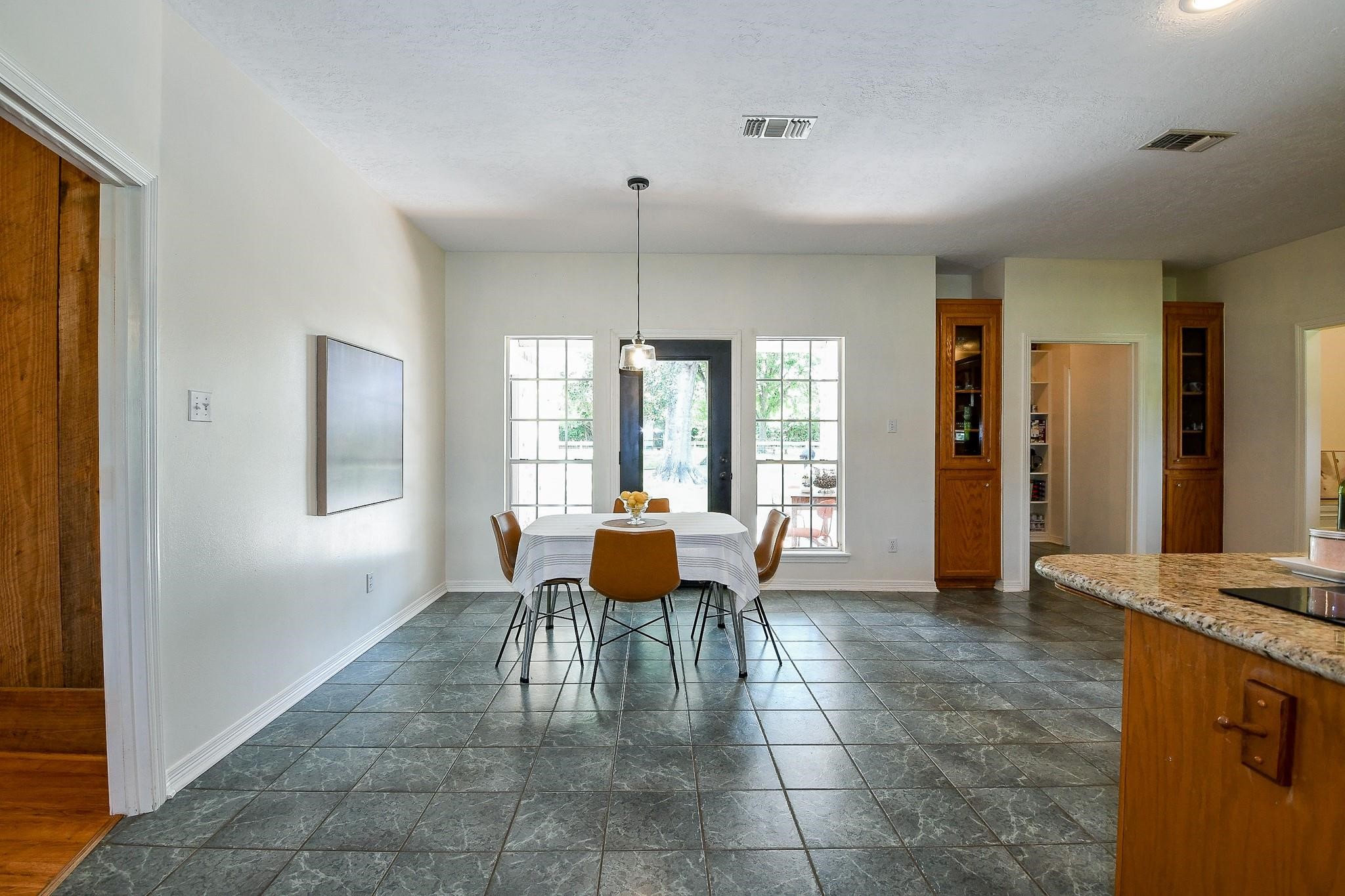 Large, open dining area with access to the covered back porch in the primary house