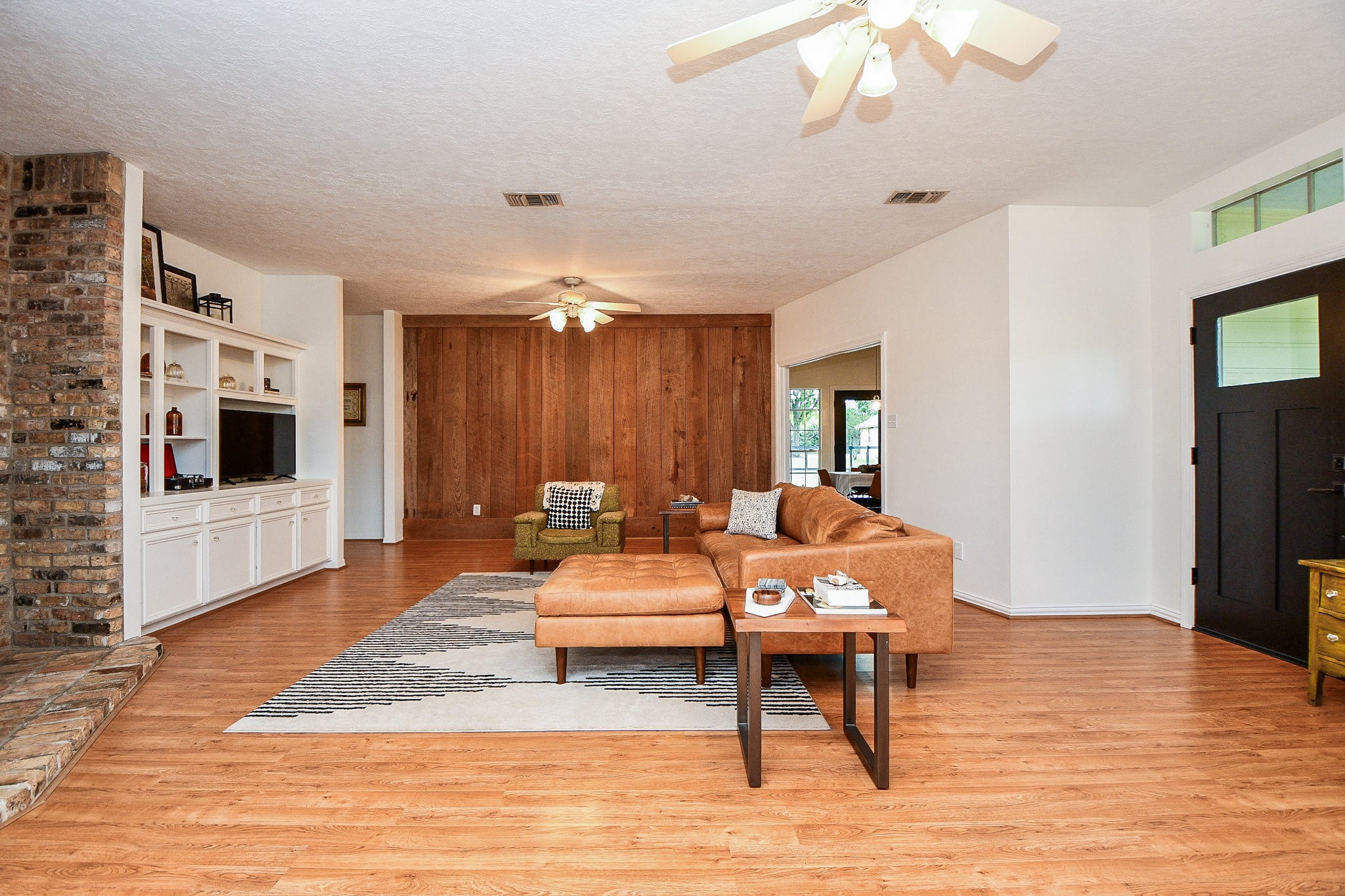 Primary house living room features a gorgeous reclaimed barn wood feature wall