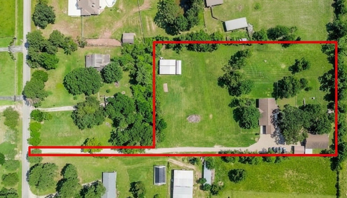 Aerial view of property with private driveway